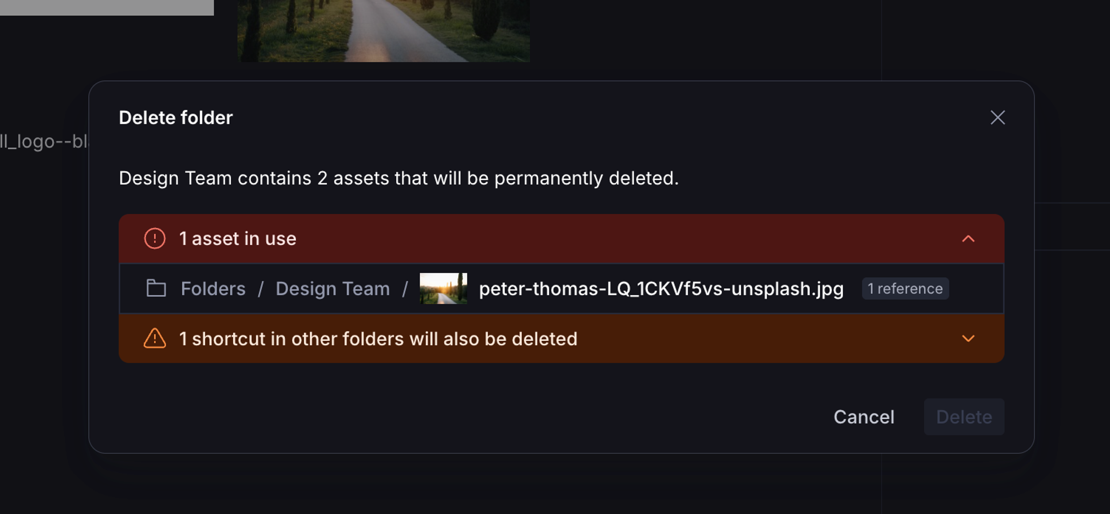 A dark-themed media library displays a "Delete folder" dialog for "Design Team," warning that 2 assets will be permanently deleted, including one in use and one shortcut from other folders.