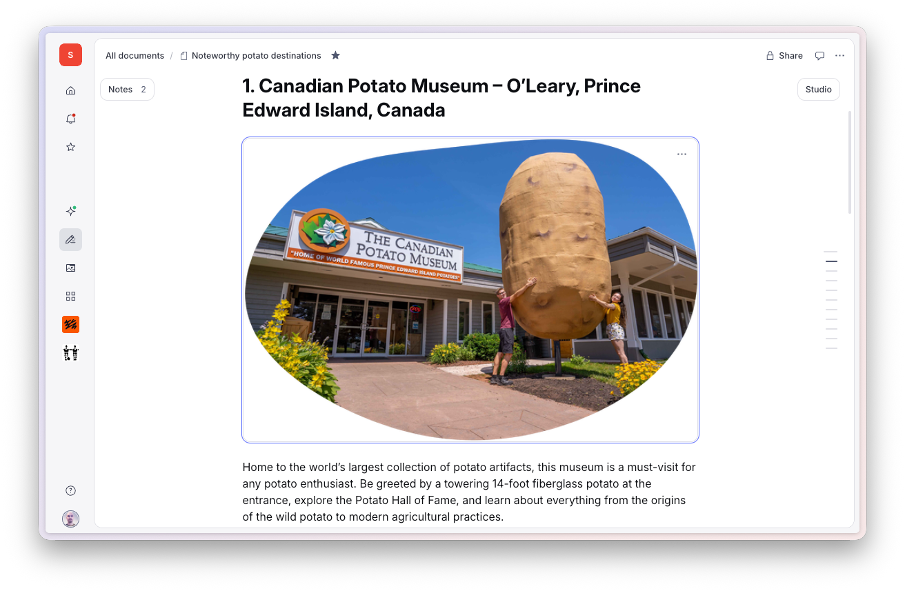 Exterior of the Canadian Potato Museum with a giant potato statue and two people posing.