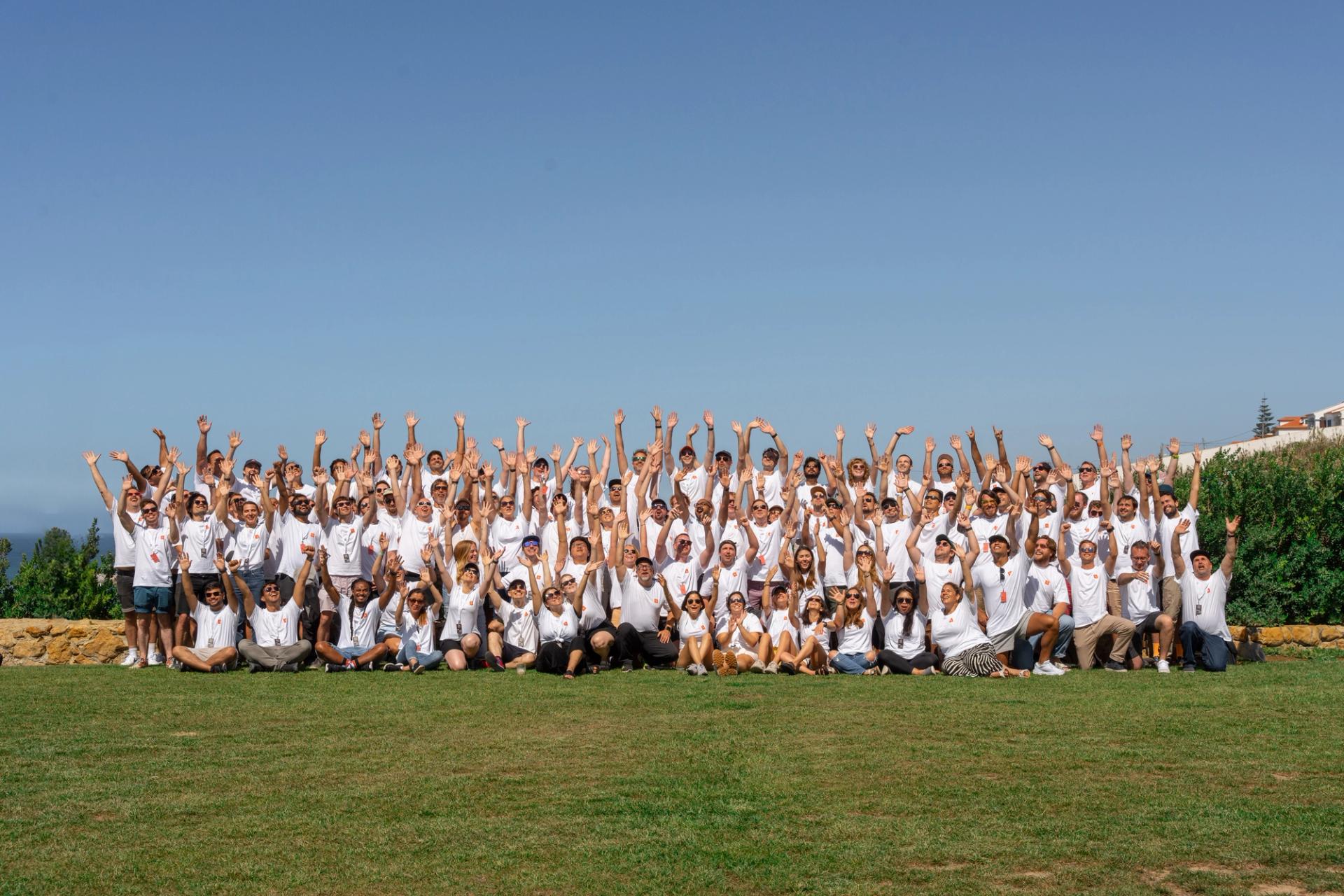 Large group of Sanity employees with hands up