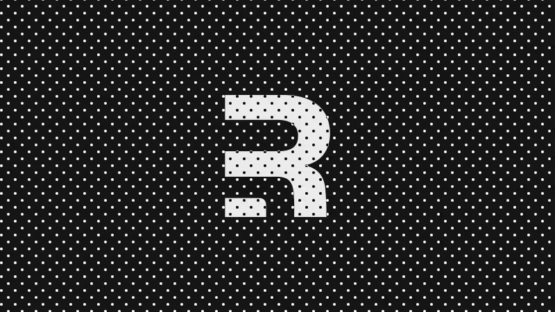 White letter R with black polka dots on a black background with white polka dots.
