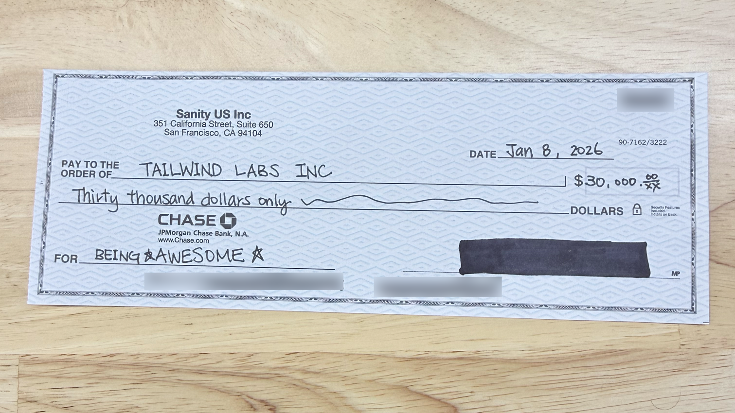 A check from Sanity US Inc to TAILWIND LABS INC for $30,000, dated Jan 8, 2026, with "FOR BEING AWESOME" in the memo.