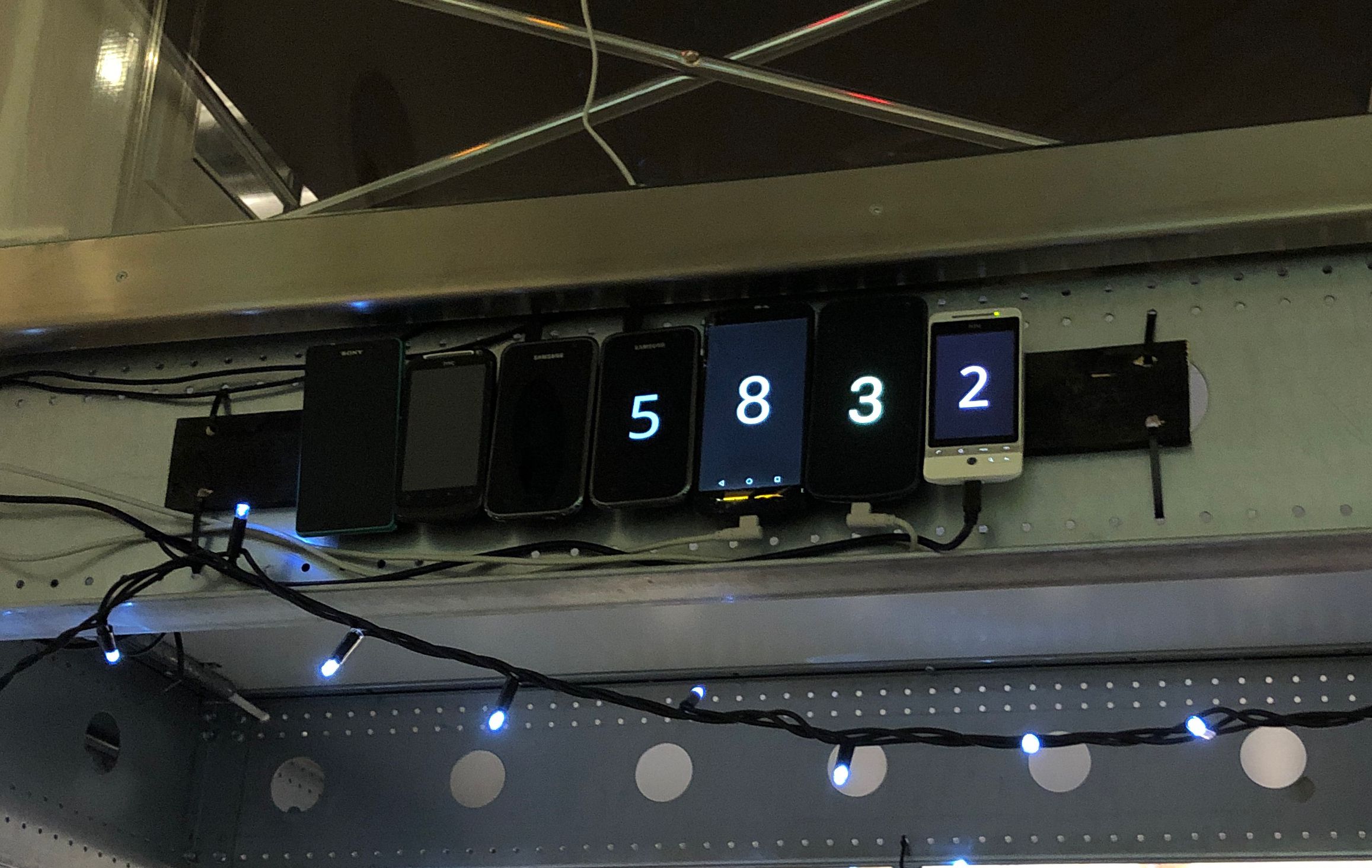 A series of seven Android phones showing digits spelling 5832