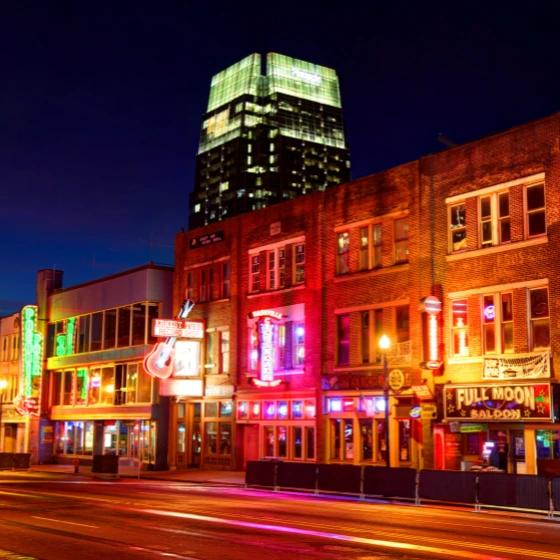 Broadway Street honky tonks at night in downtown Nashville, TN