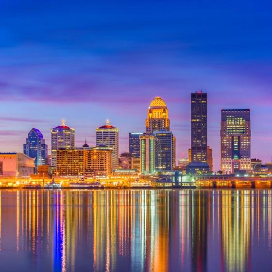 Louisville, KY skyline at night reflected in the Ohio River