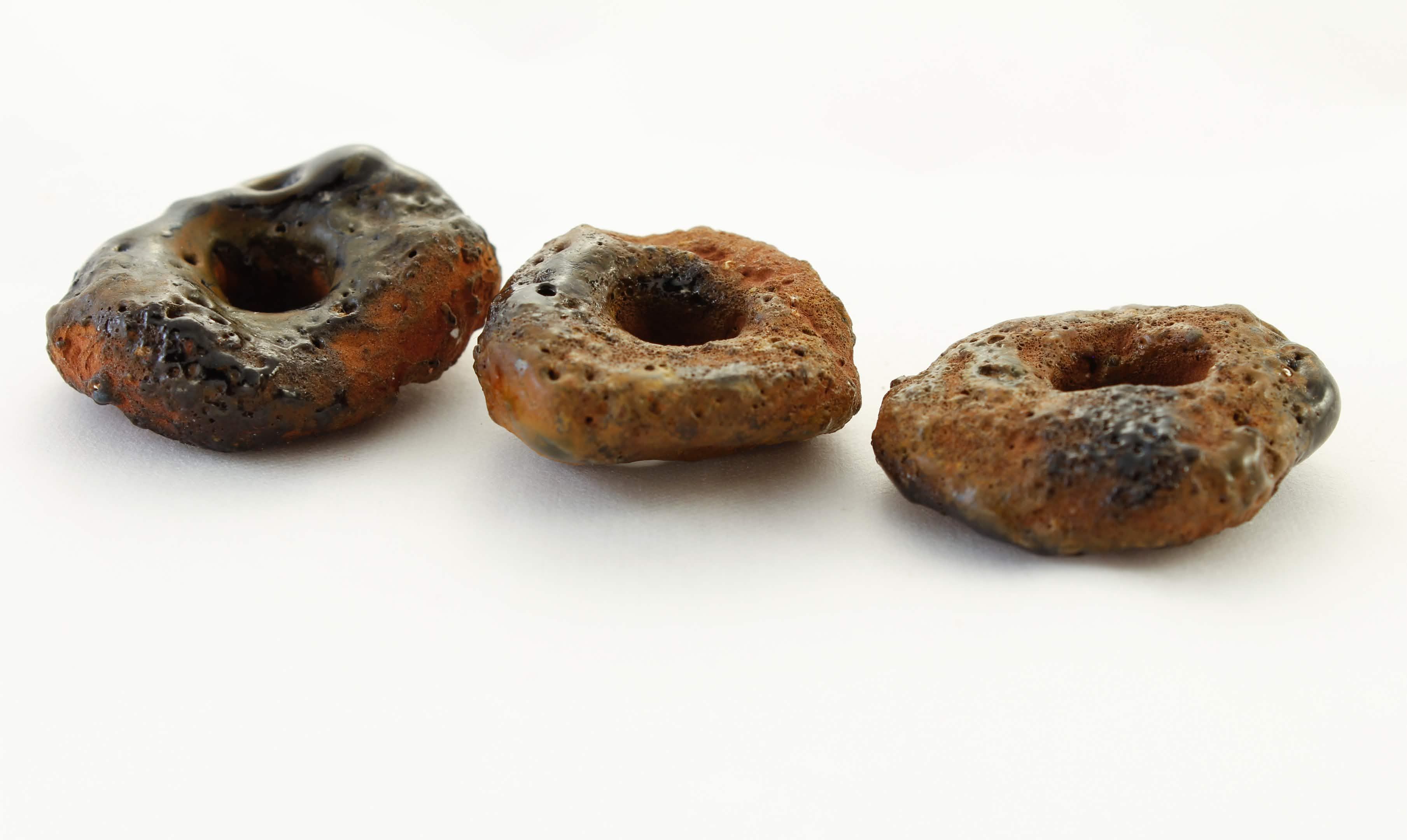 Three circular ceramic objects