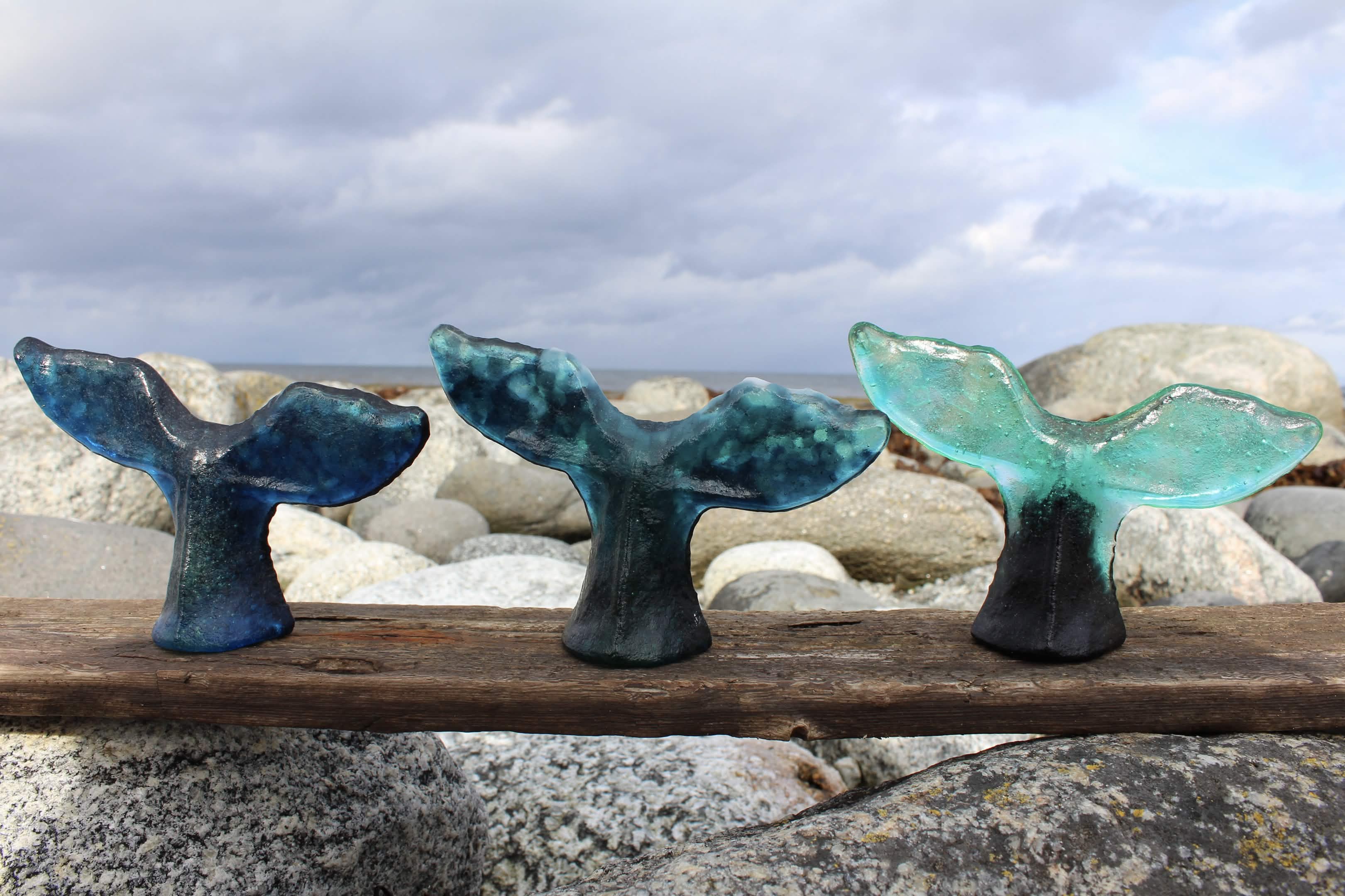 Three whale tail sculptures
