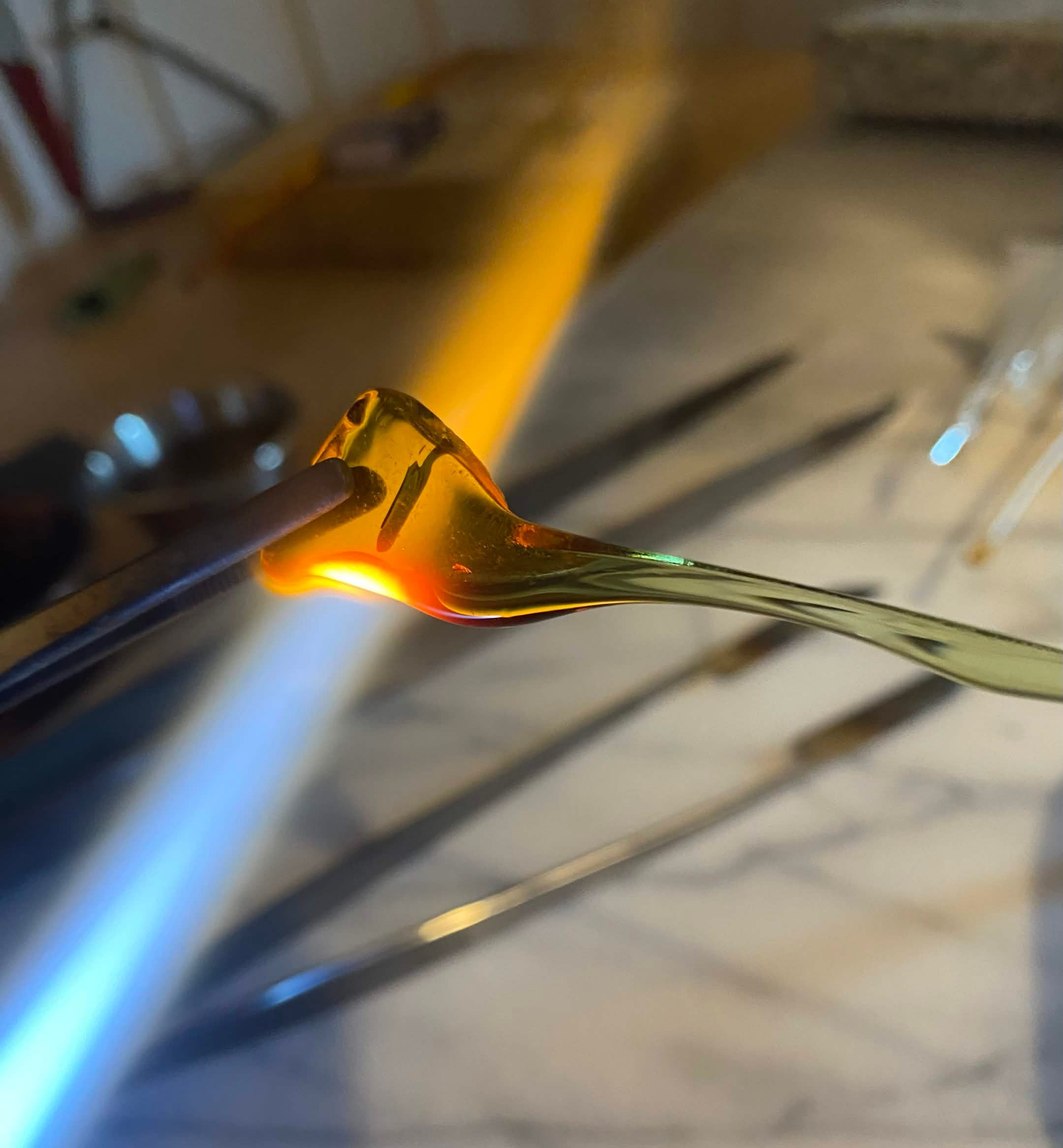 Glass being formed in flames