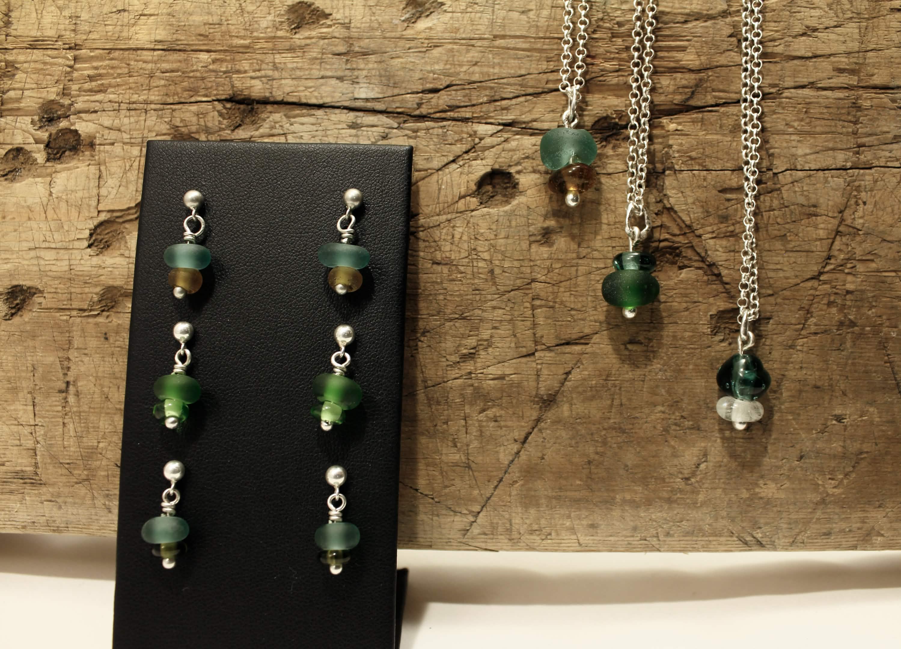 Earrings and necklaces on wood