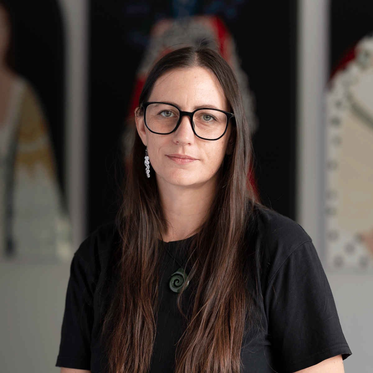 Photography by Adrian Vercoe. Image of artist Ayesha Green sitting in front of her works