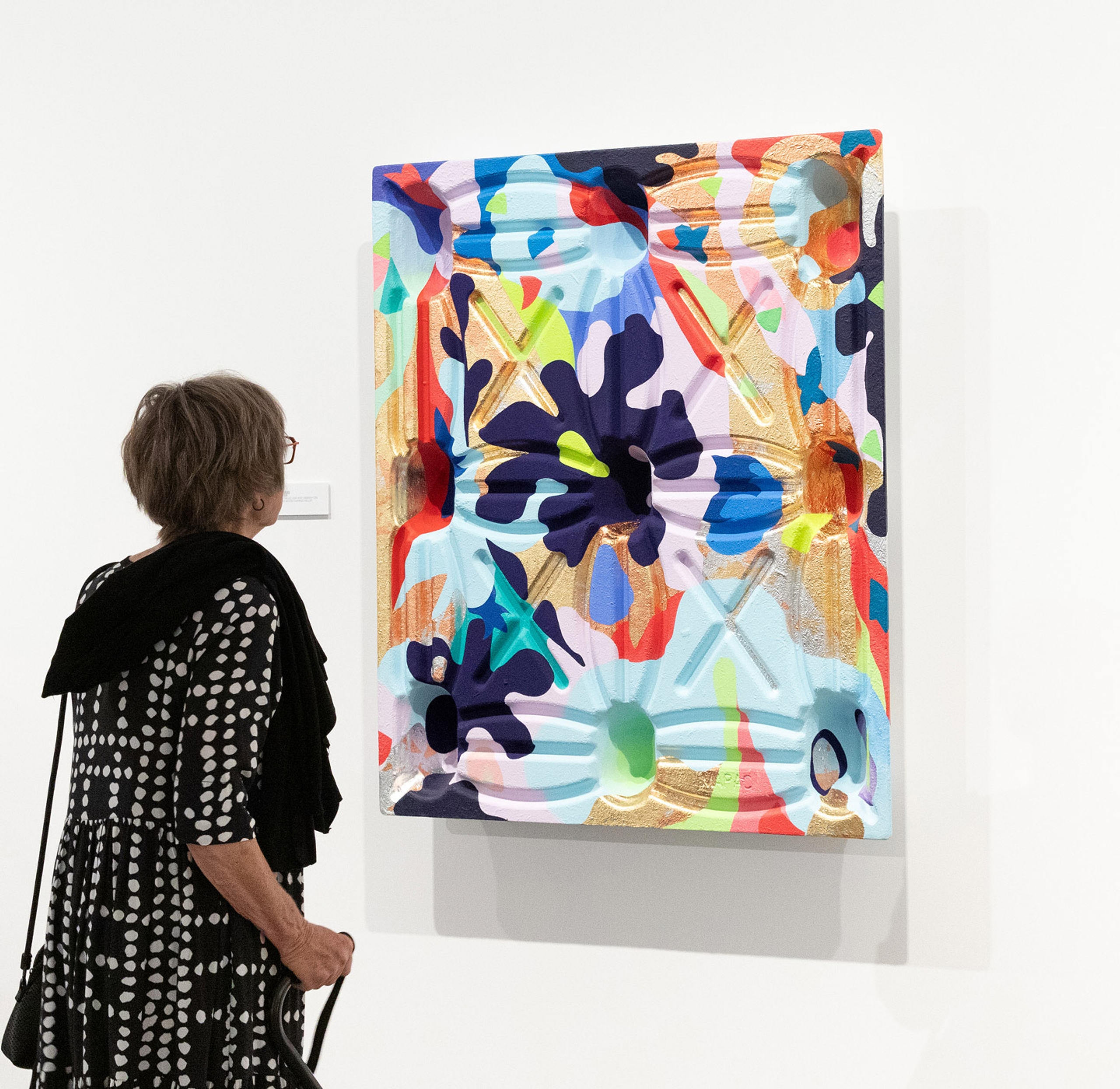 Visitor looking at a painting