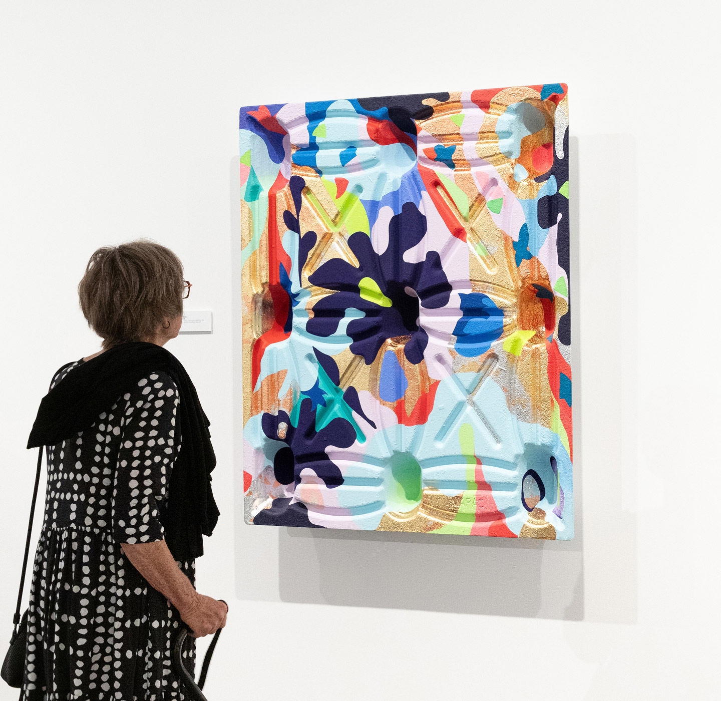 Visitor looking at a painting