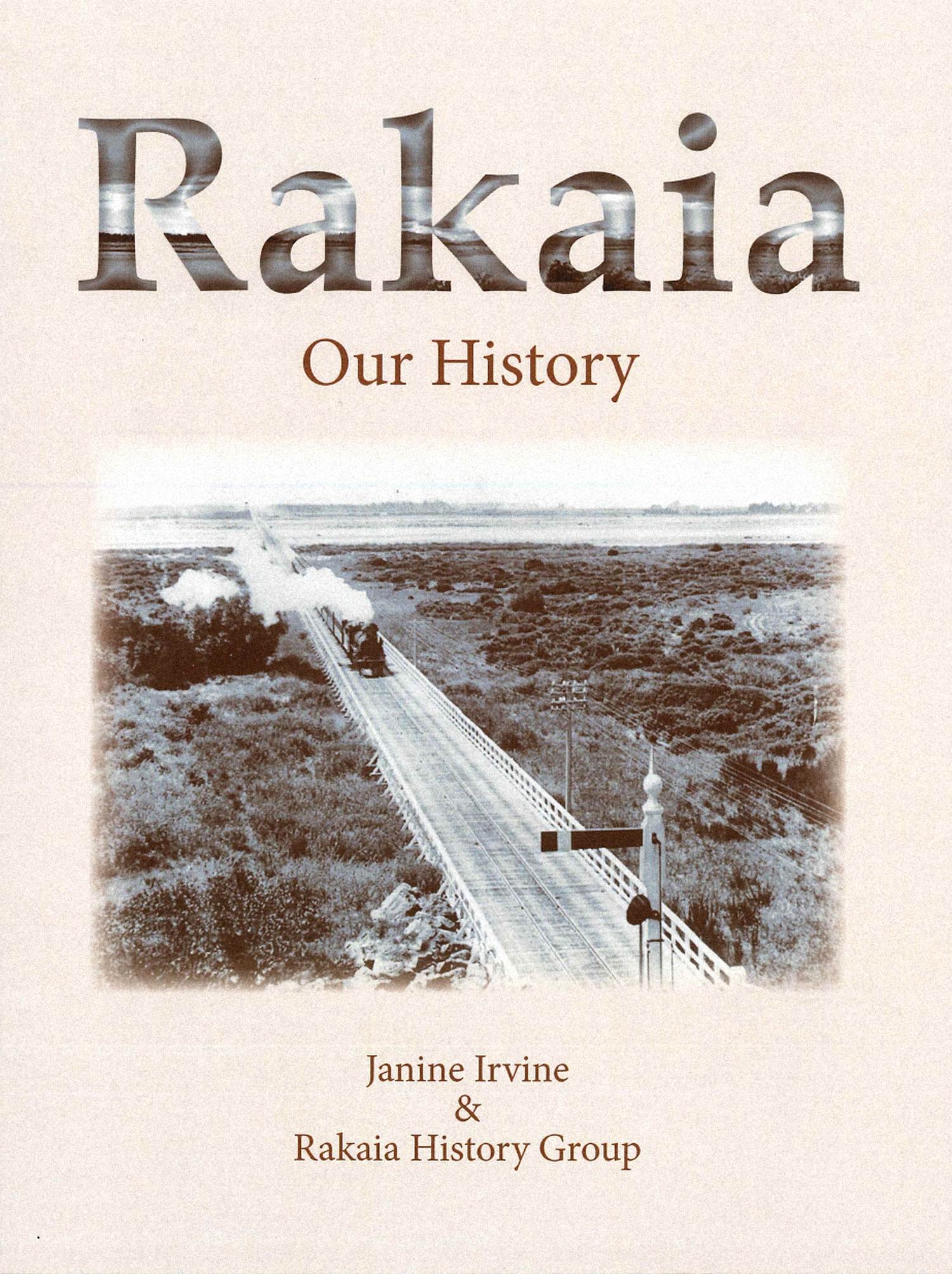 Cover of the book Rakaia: Our History by Janine Irvine and the Rakaia History Group, showing an aerial photograph of a road and railway line.