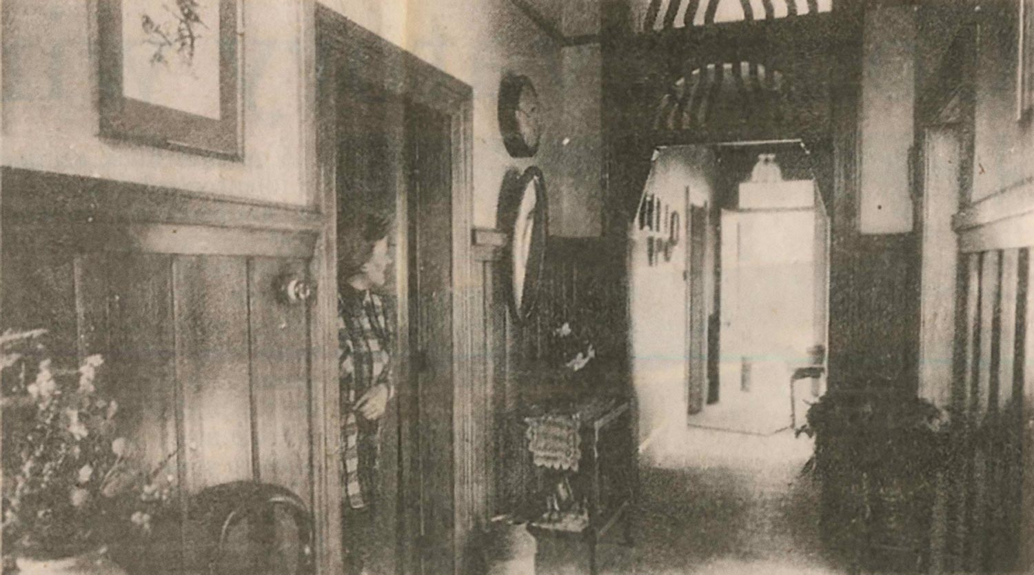Hallway of a restored Moore Street villa with heart rimu woodwork and a matching arch.
