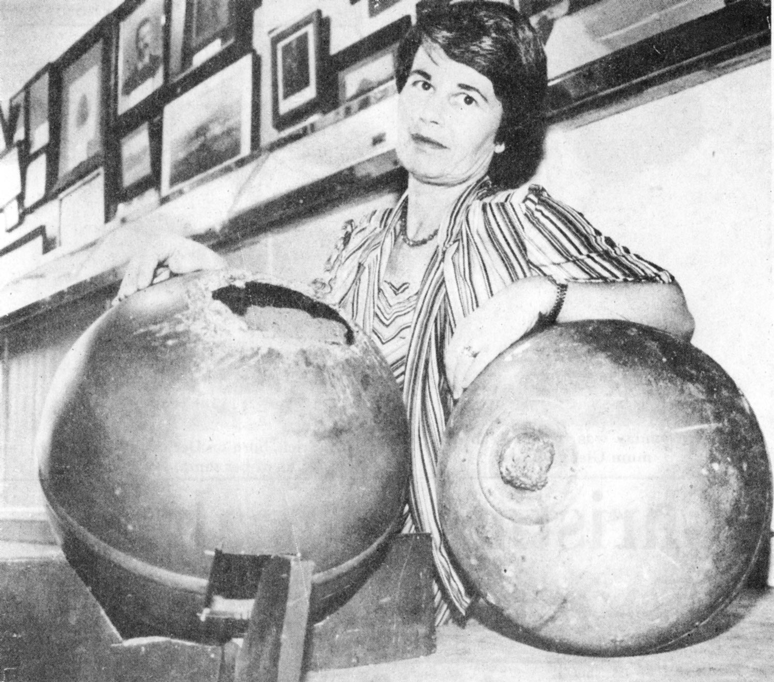 Rita Wright posing with two of the space balls
