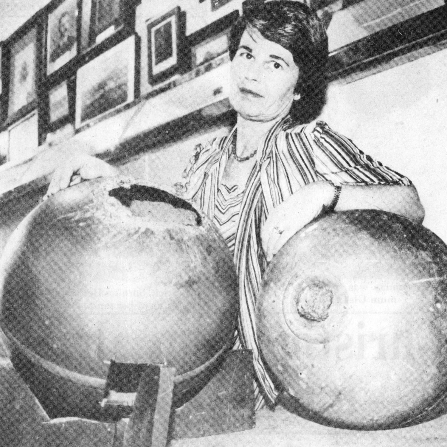 Rita Wright posing with two of the space balls.