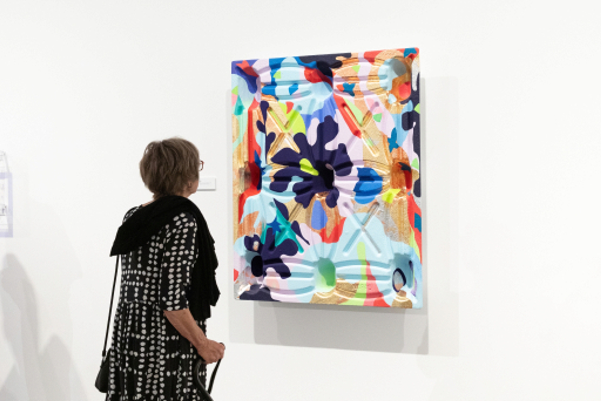 Visitor looking at a painting