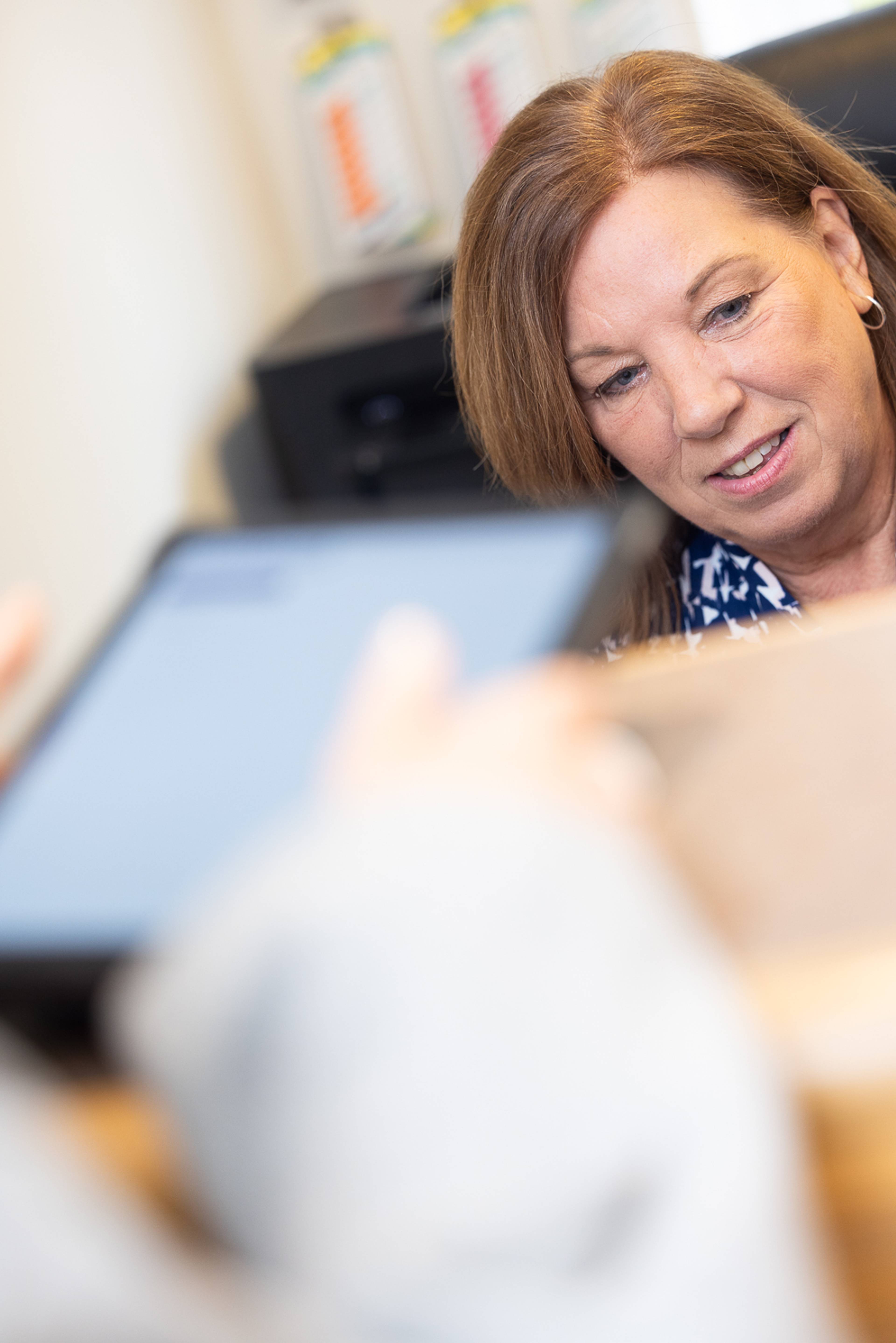 A patient paying for treatment using a tablet at the practice