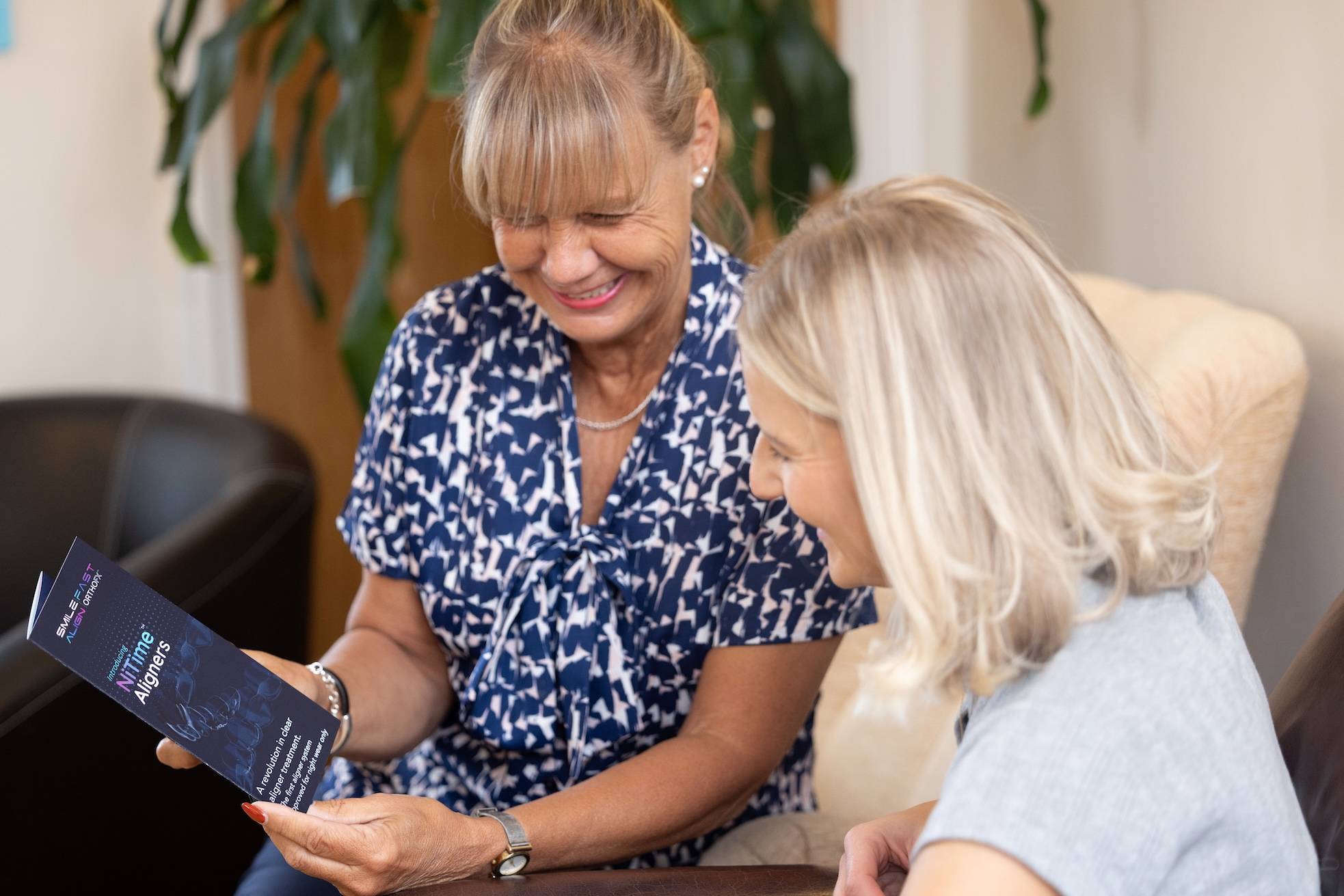 Reception staff showing patient a flyer in waiting room