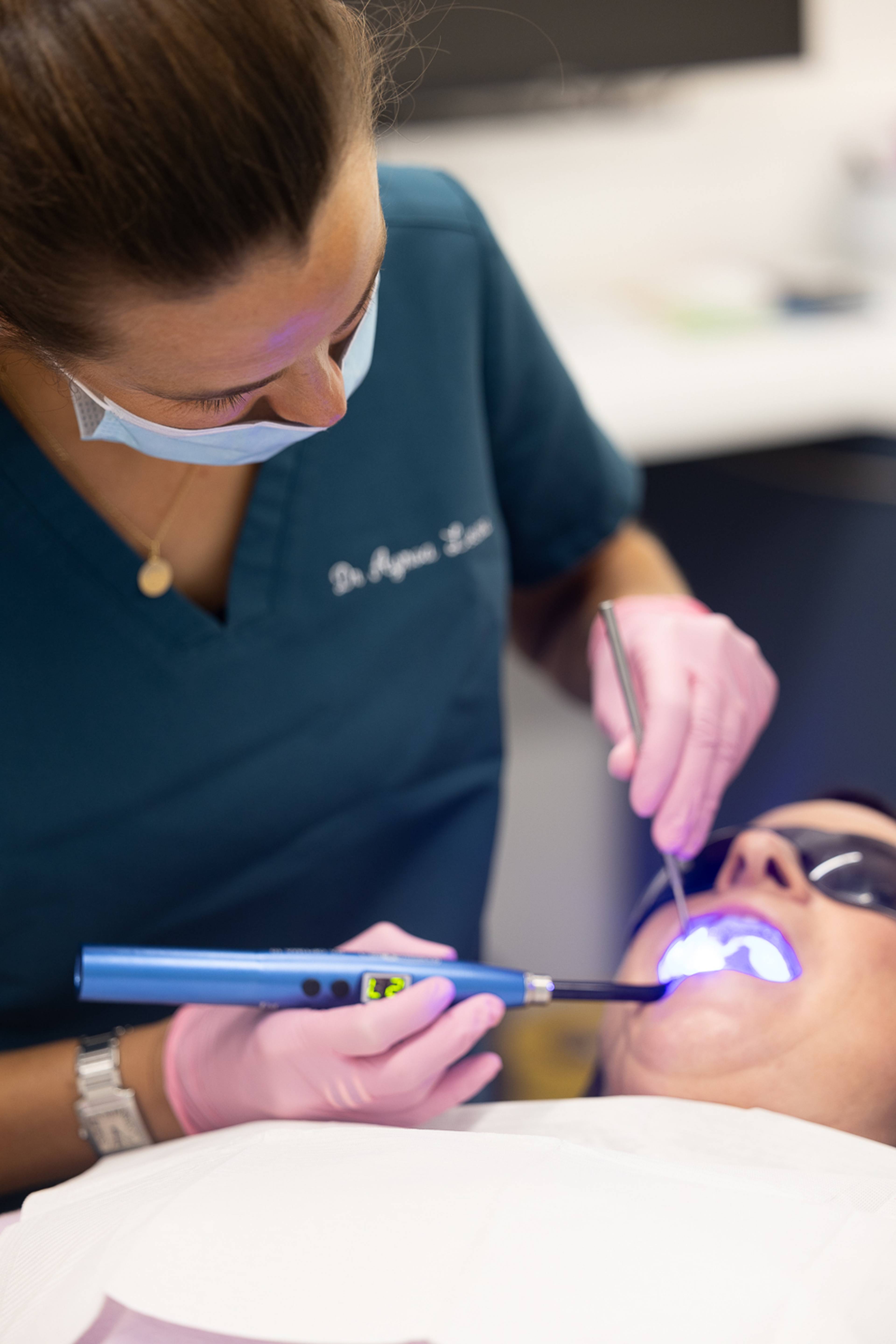 dentist working on a patient with a bright light