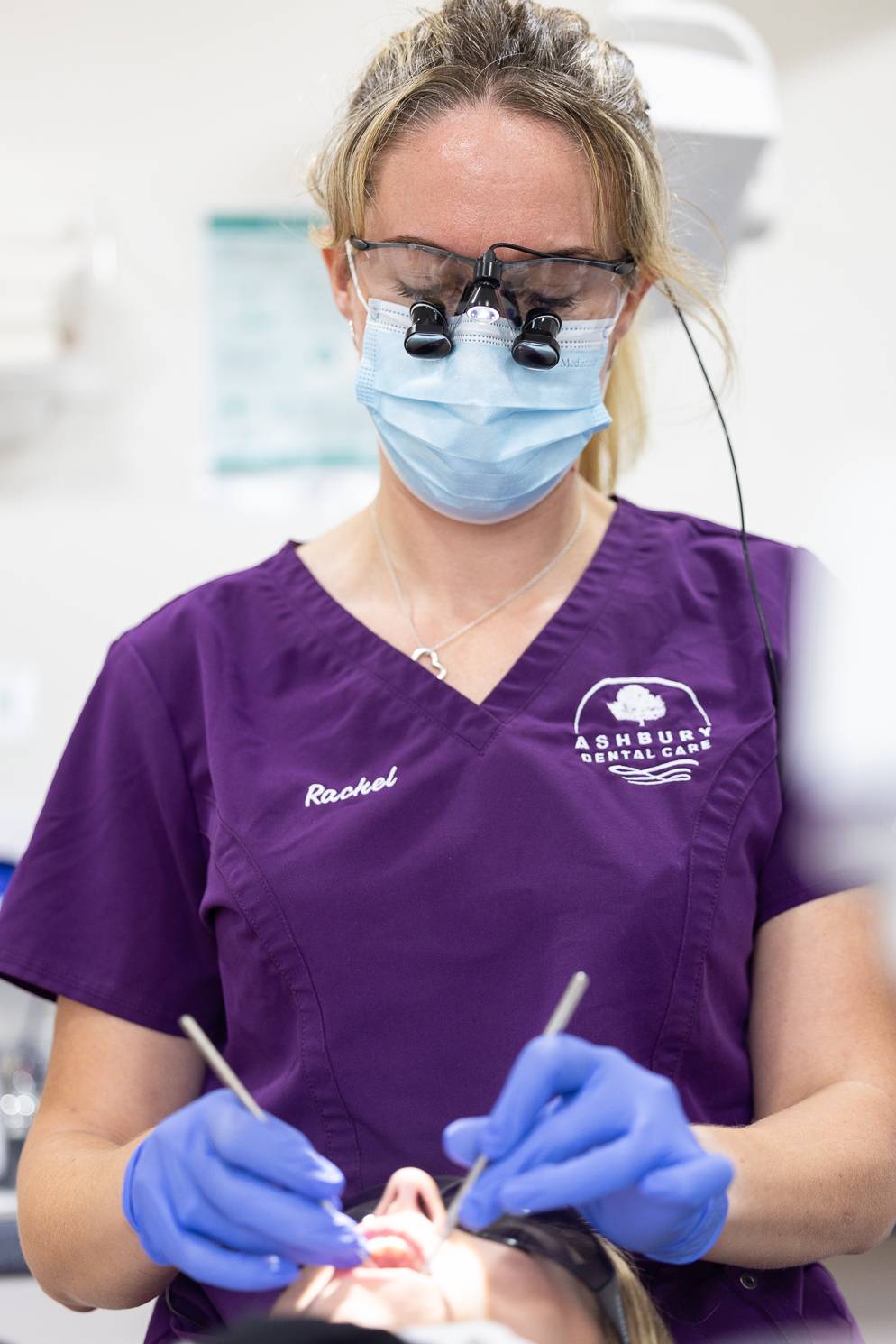 One of the dentists at Ashbury Dental Care working on her patient using some dental tools