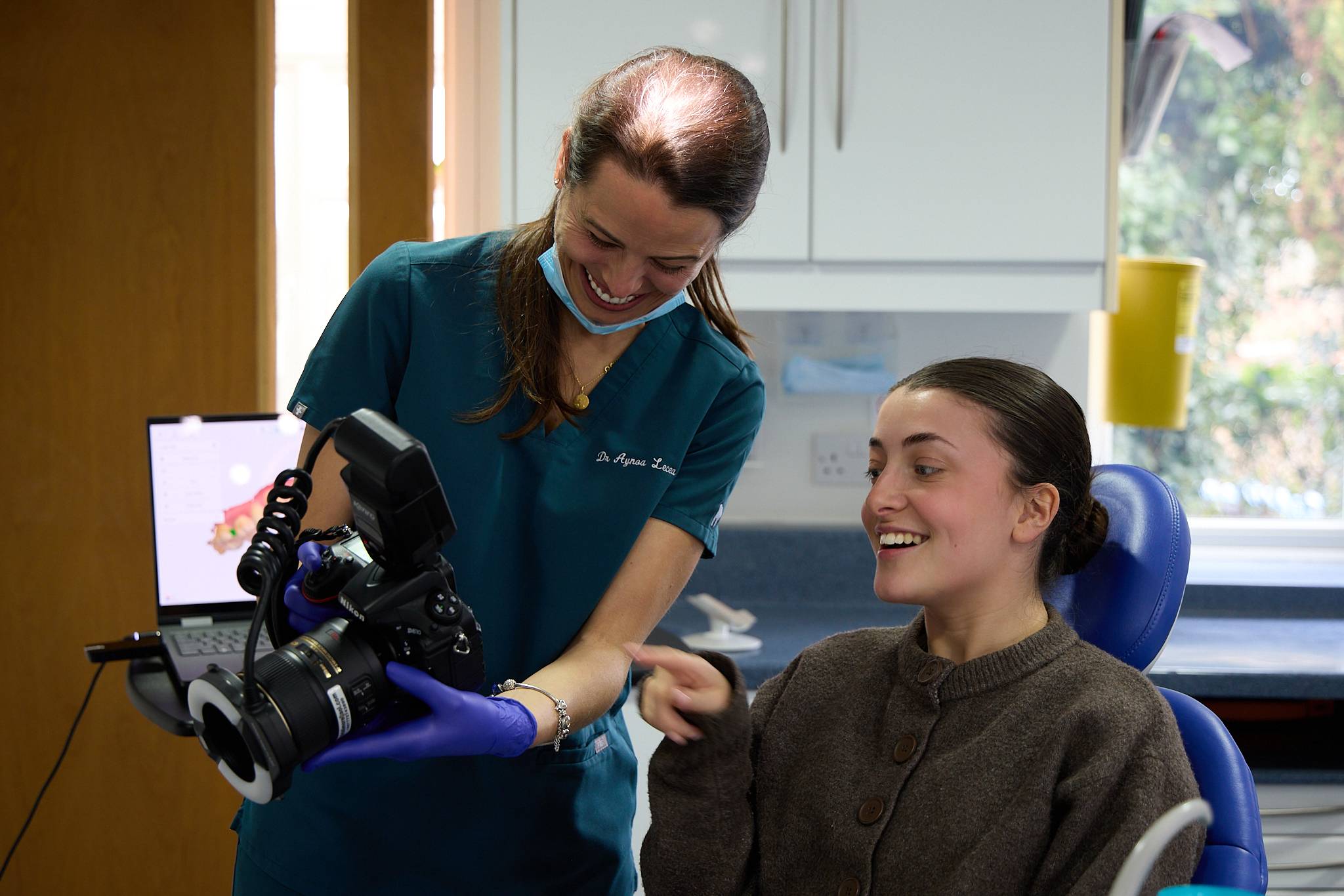 A dentist showing a patient photos on the camera