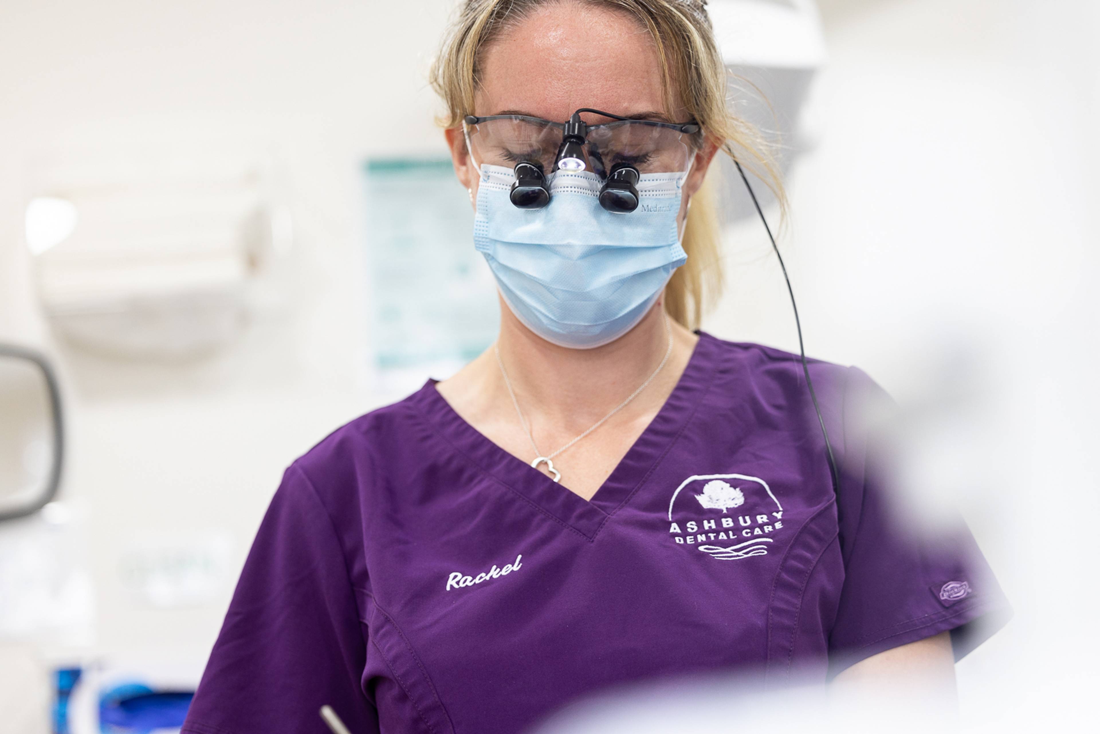 A dentist wearing loupes