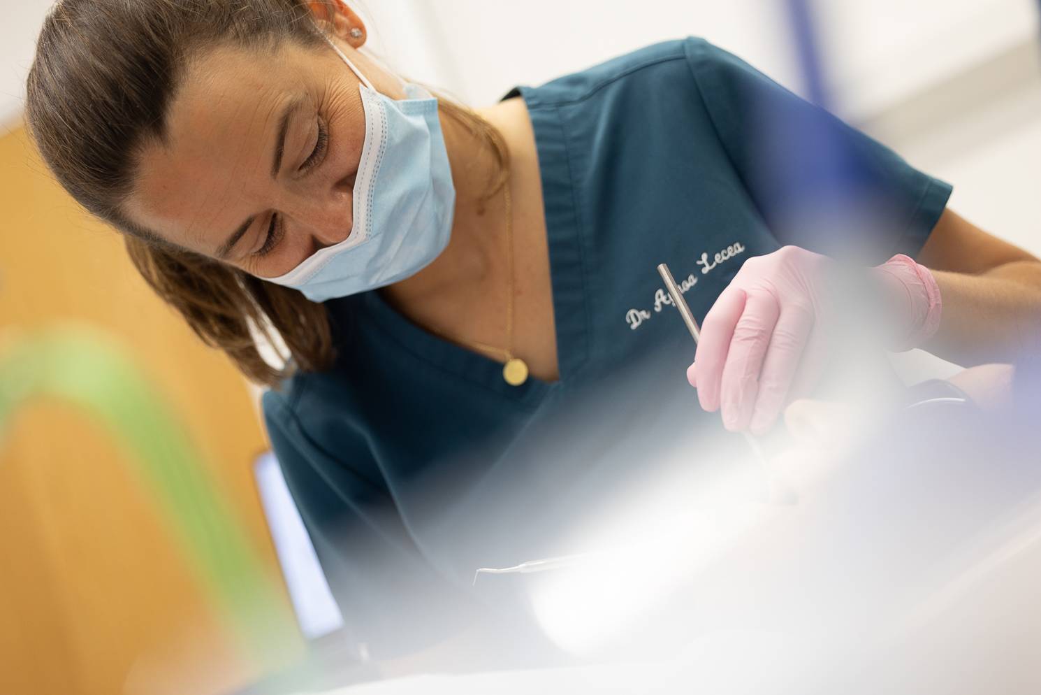 A dentist working on a patient with dental tools
