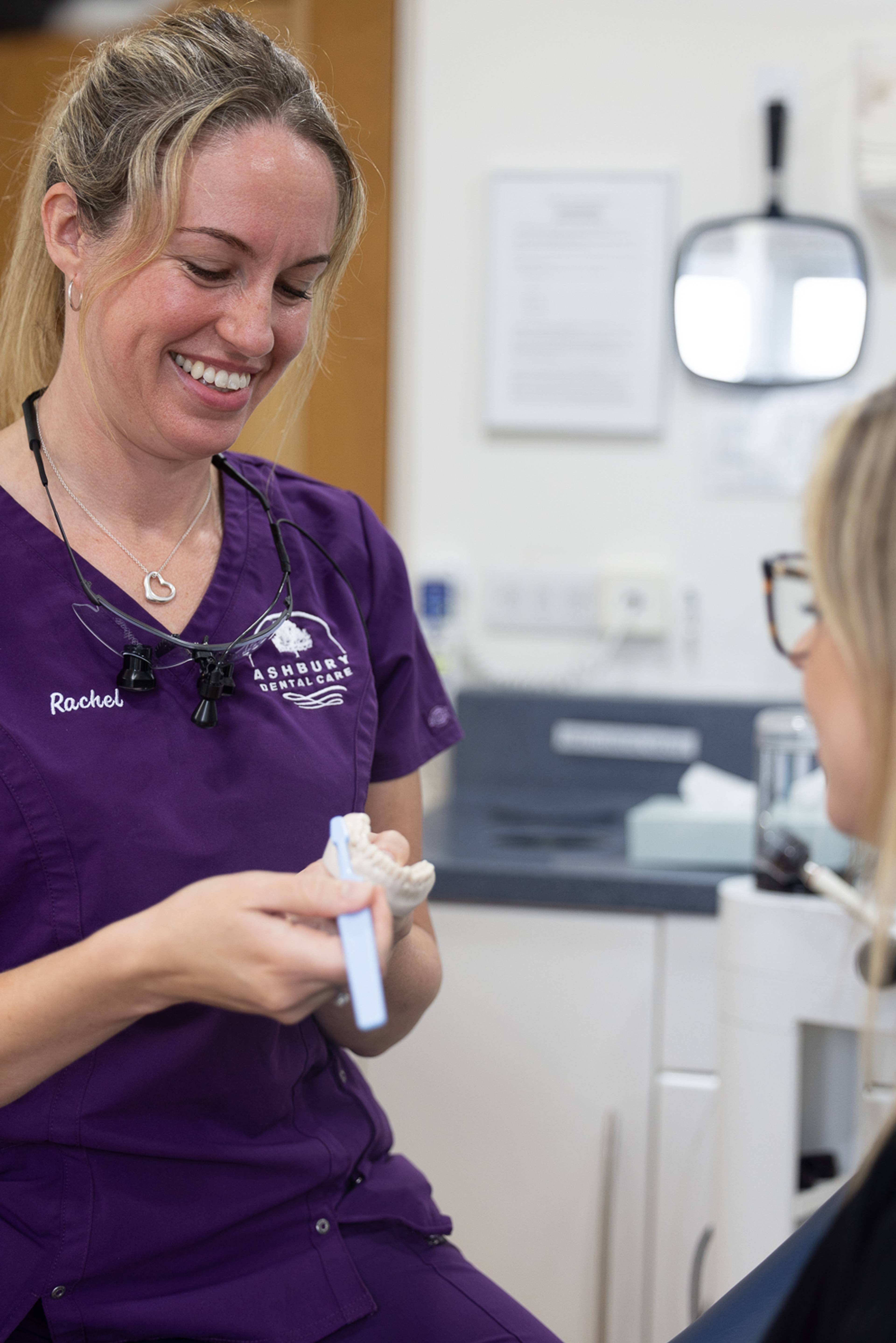 a dentist demonstrates proper brushing technique