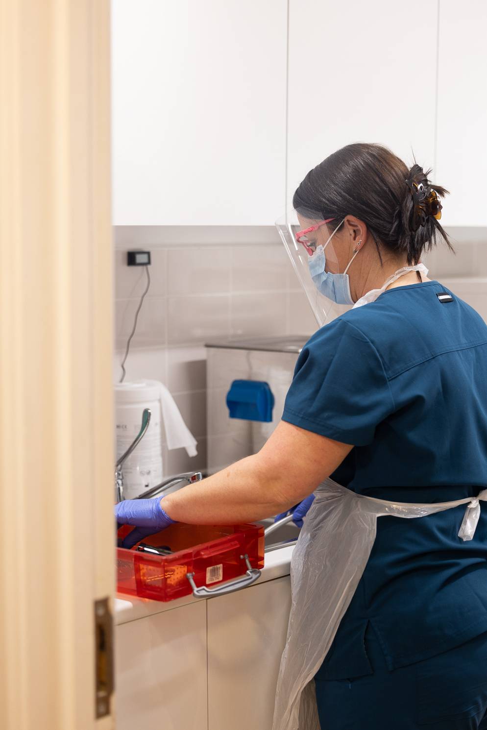 A member of the practice team organises dental equipment