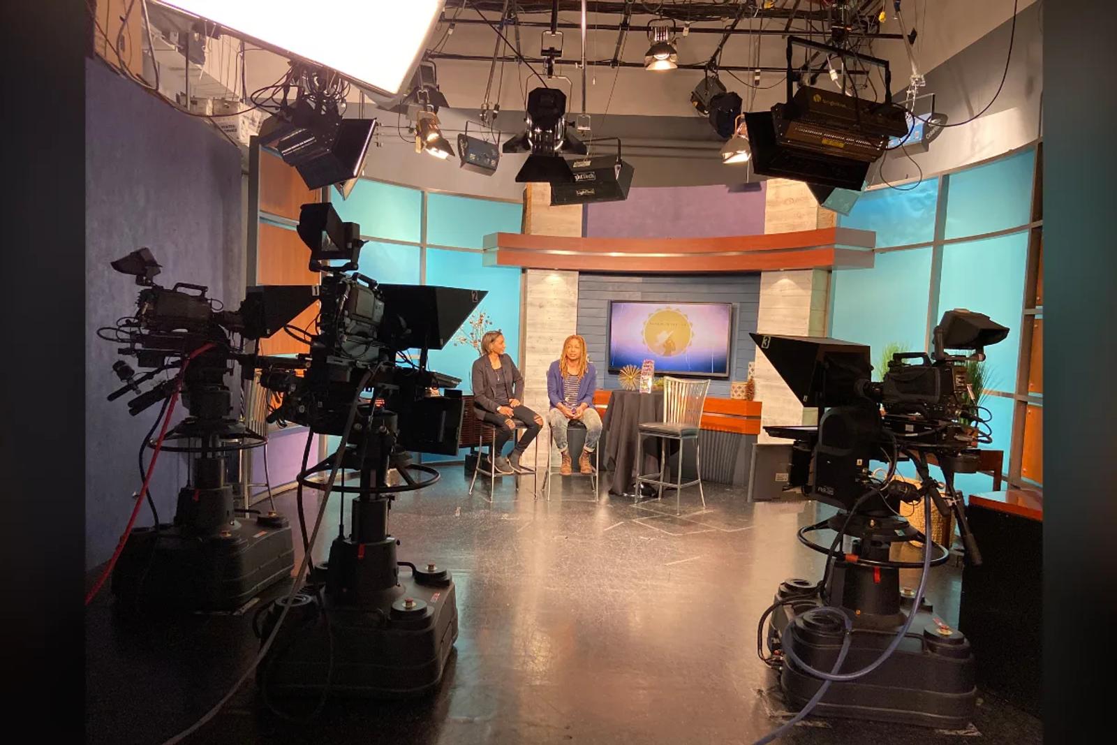 Raasin McIntosh in a TV studio interview during a Raasin in the Sun production
