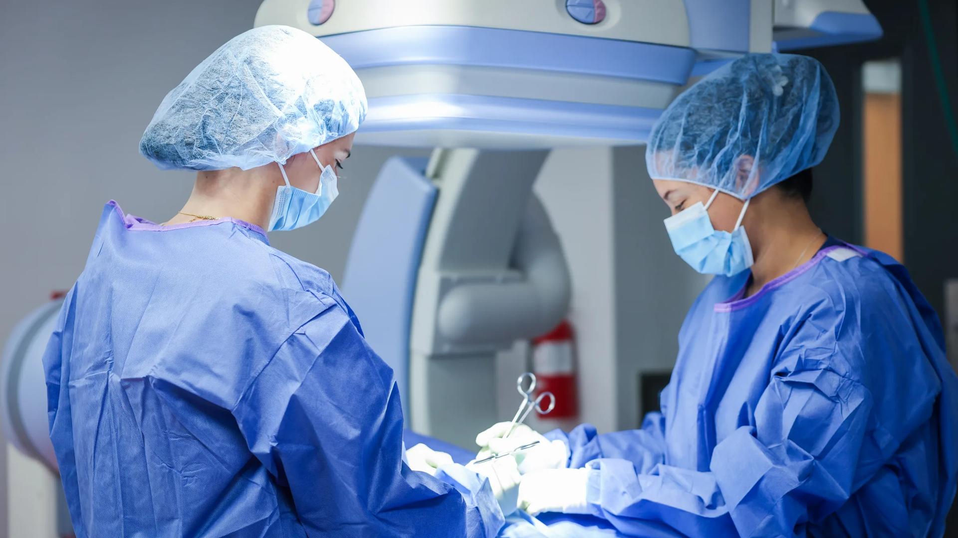 Surgeons performing peripheral vascular intervention with C-arm imaging at Synchrony Labs
