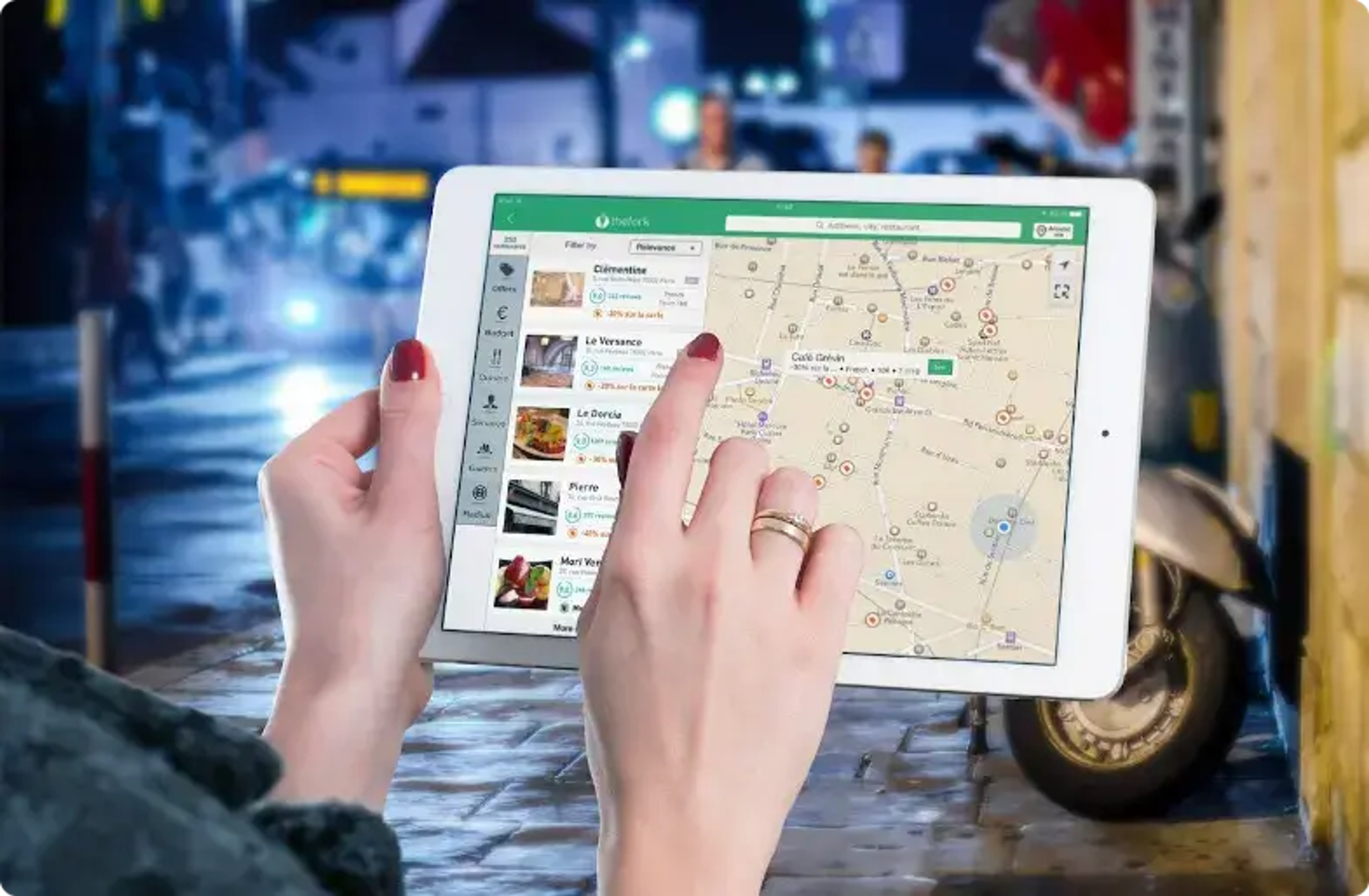 Tablet viser et Google Maps-kort med hænder, der holder skærmen