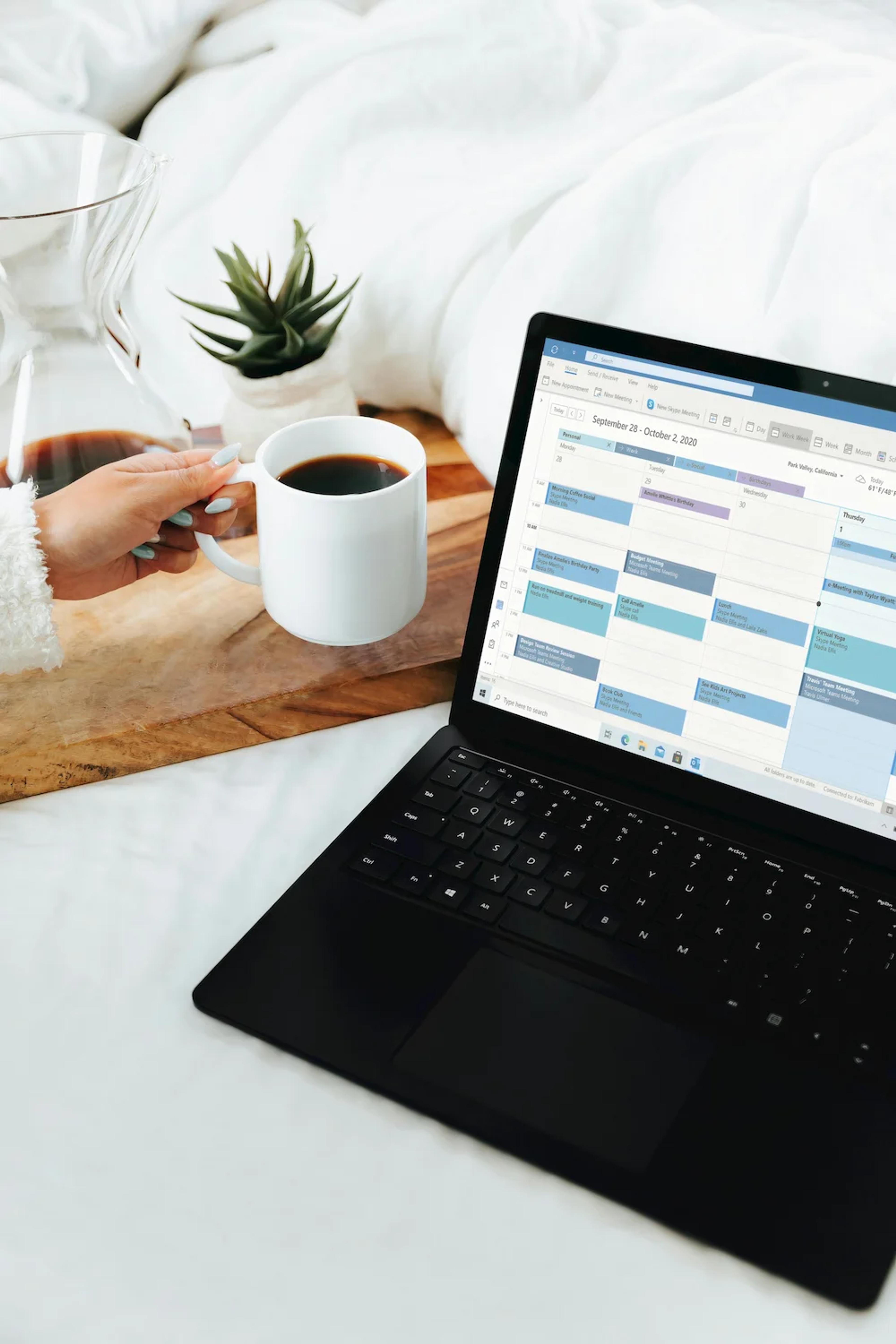 Tour operator reviewing schedules and bookings at a laptop in an office setting.