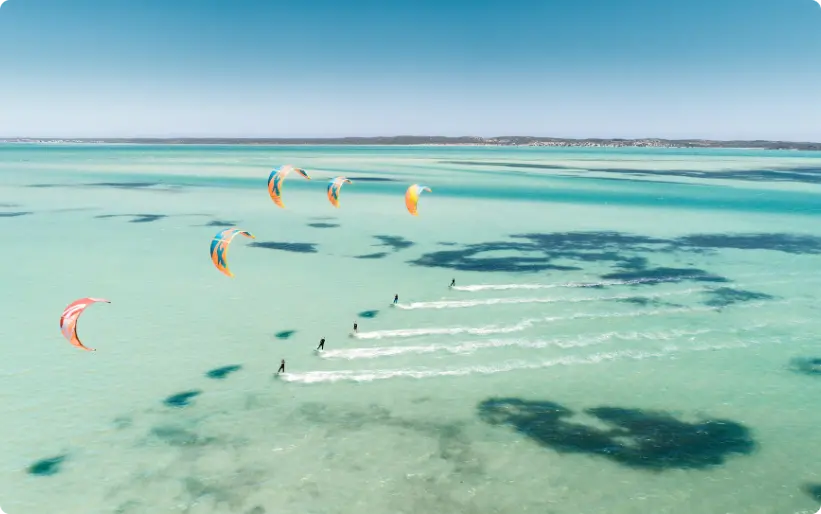 cinq personnes faisant du parapente à la mer pendant la journée