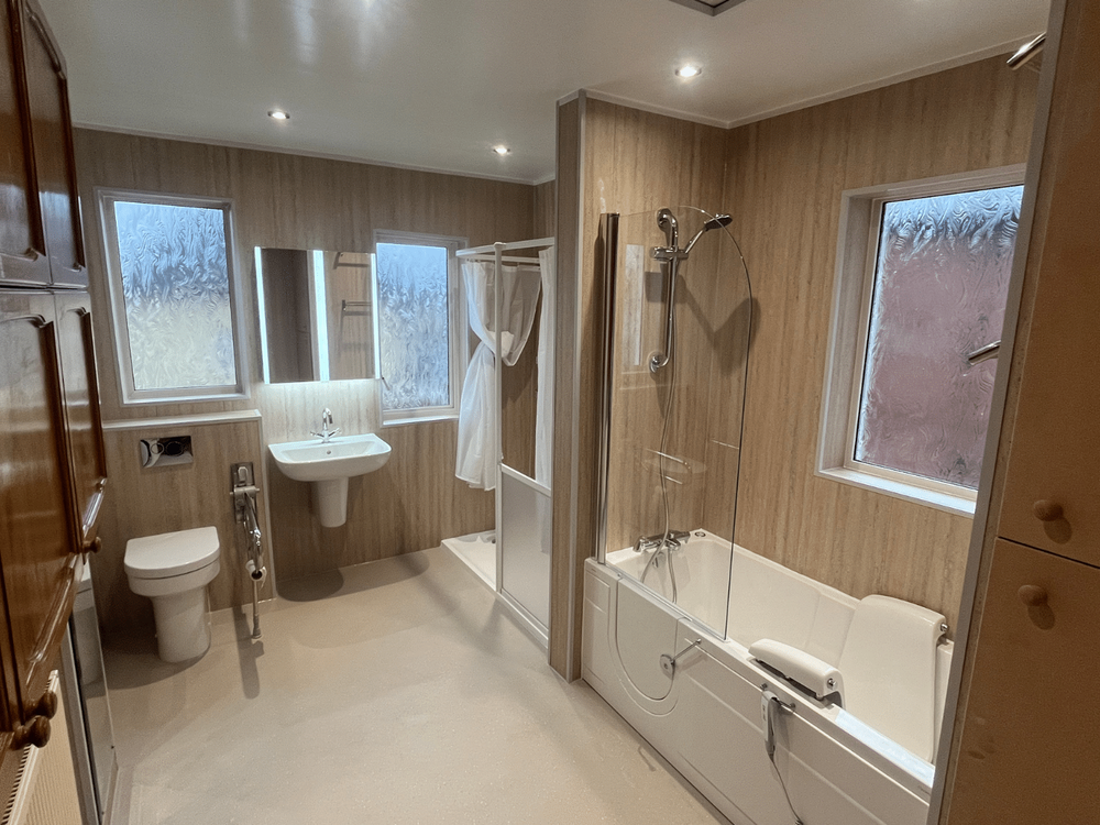 A modern accessible walk-in bathroom installed by Age Care