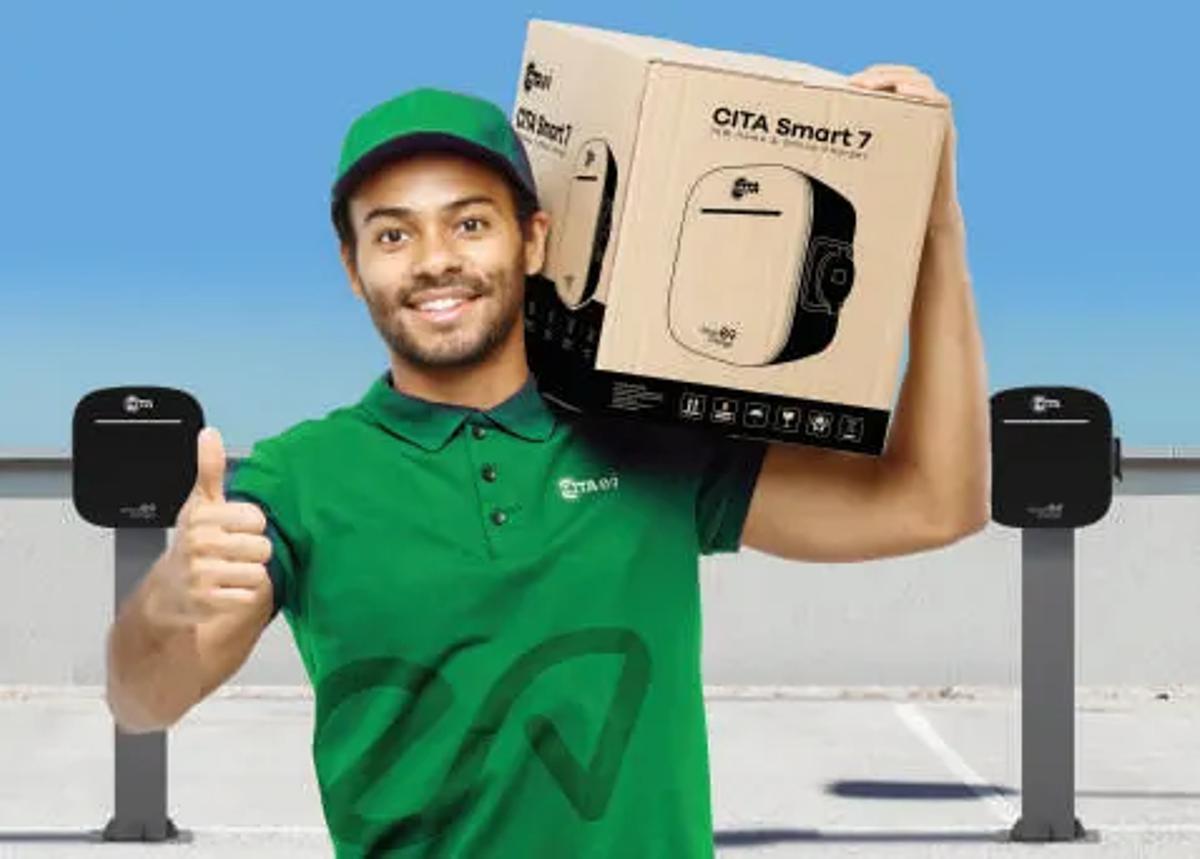 An engineer holding a boxed CITA Smart 7 charger