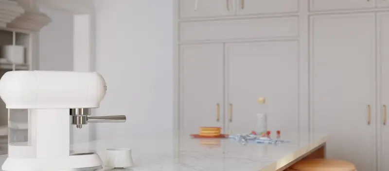 Een moderne keukenmachine op een keukenblad omringd door ingrediënten en accessoires