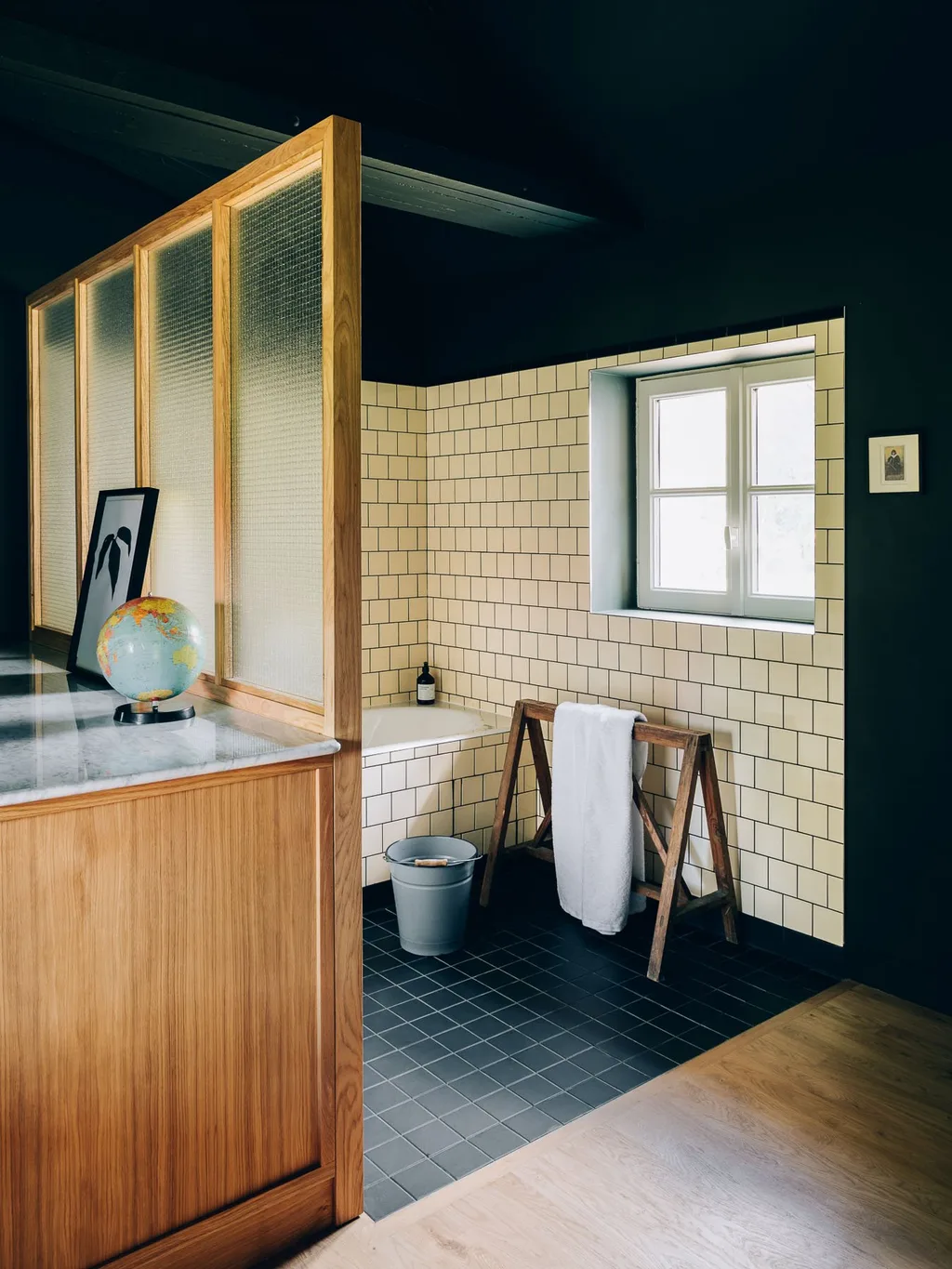 Yellow subway-tiled bathroom with a freestanding tub by the window, Le Barn hotel
