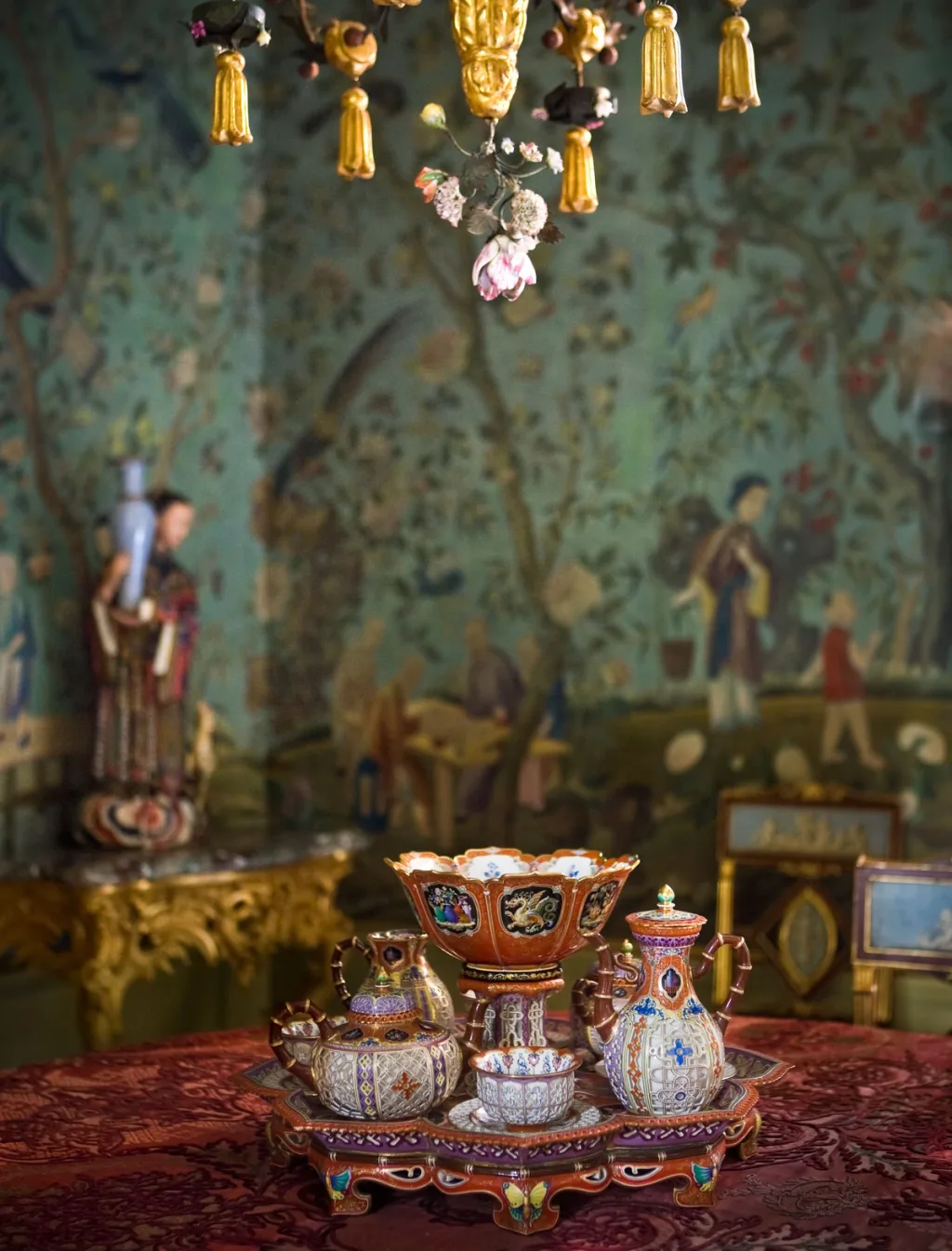 Ornate colourful vessels on a tray against green painted wall panels, Pierre Bergé, Paris
