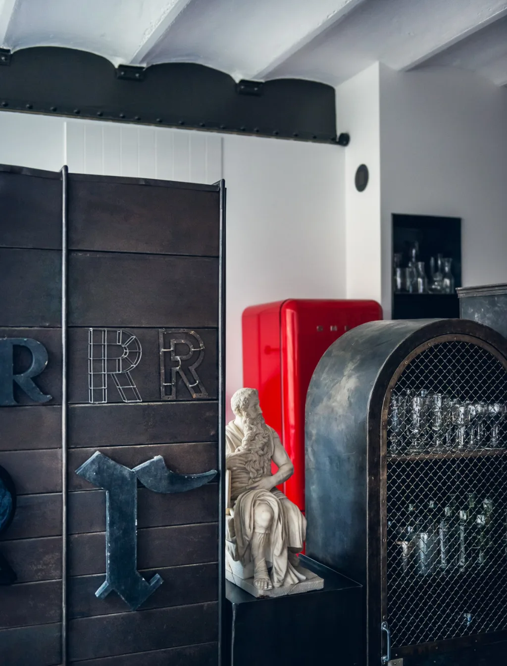 Letter R display, seated statue and red refrigerator at Daniel Rozensztroch's Paris home