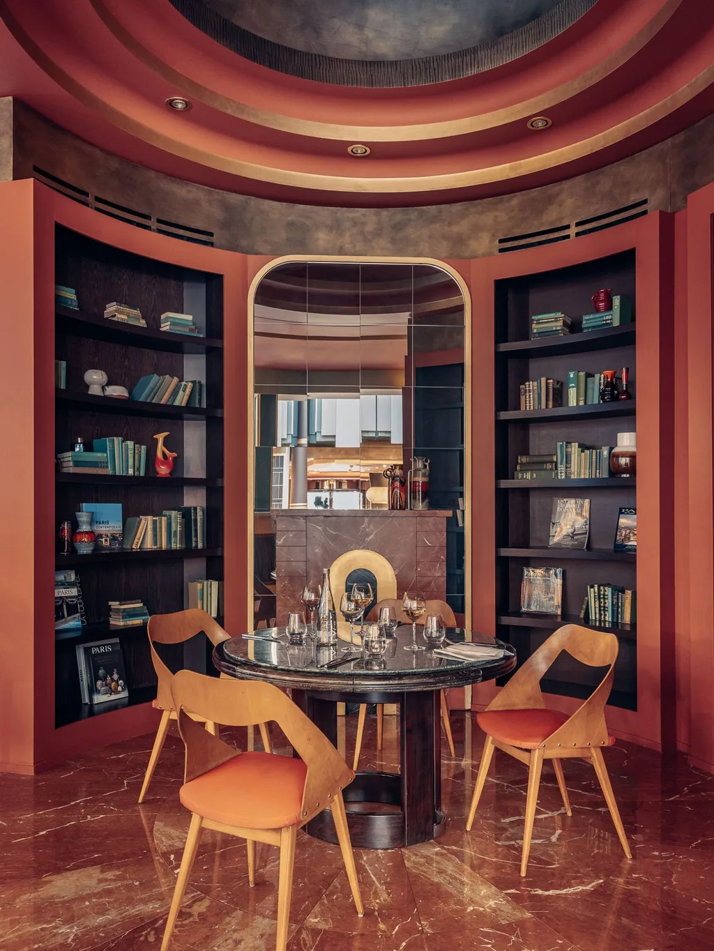 Reading nook with built-in bookshelves and round marble-top table, Nest MGallery Hotel, Paris