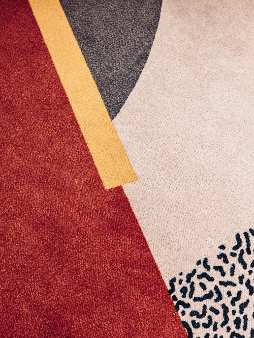 Close-up of geometric carpet in red, yellow, grey and leopard print, Nest MGallery Hotel, Paris