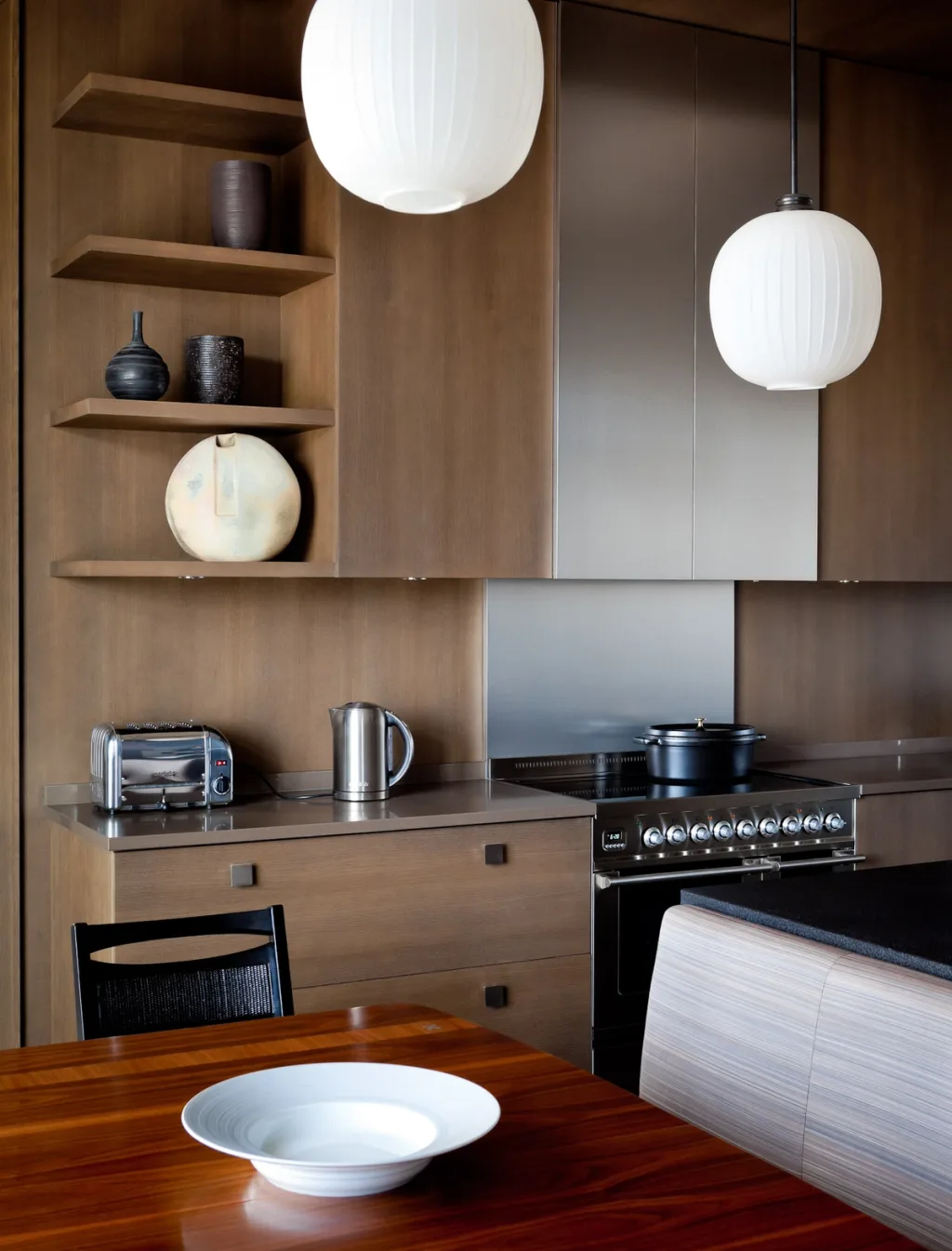 Wood-panelled kitchen with display shelves and white pendant lights, Jean Louis Deniot, Paris