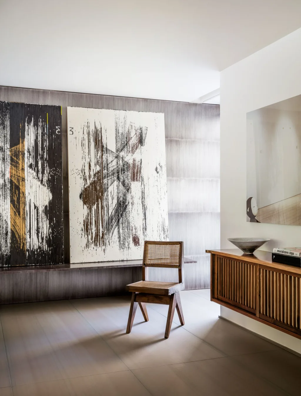 Wooden chair between large abstract artwork and a floating sideboard, Olivier Dwek, Paris
