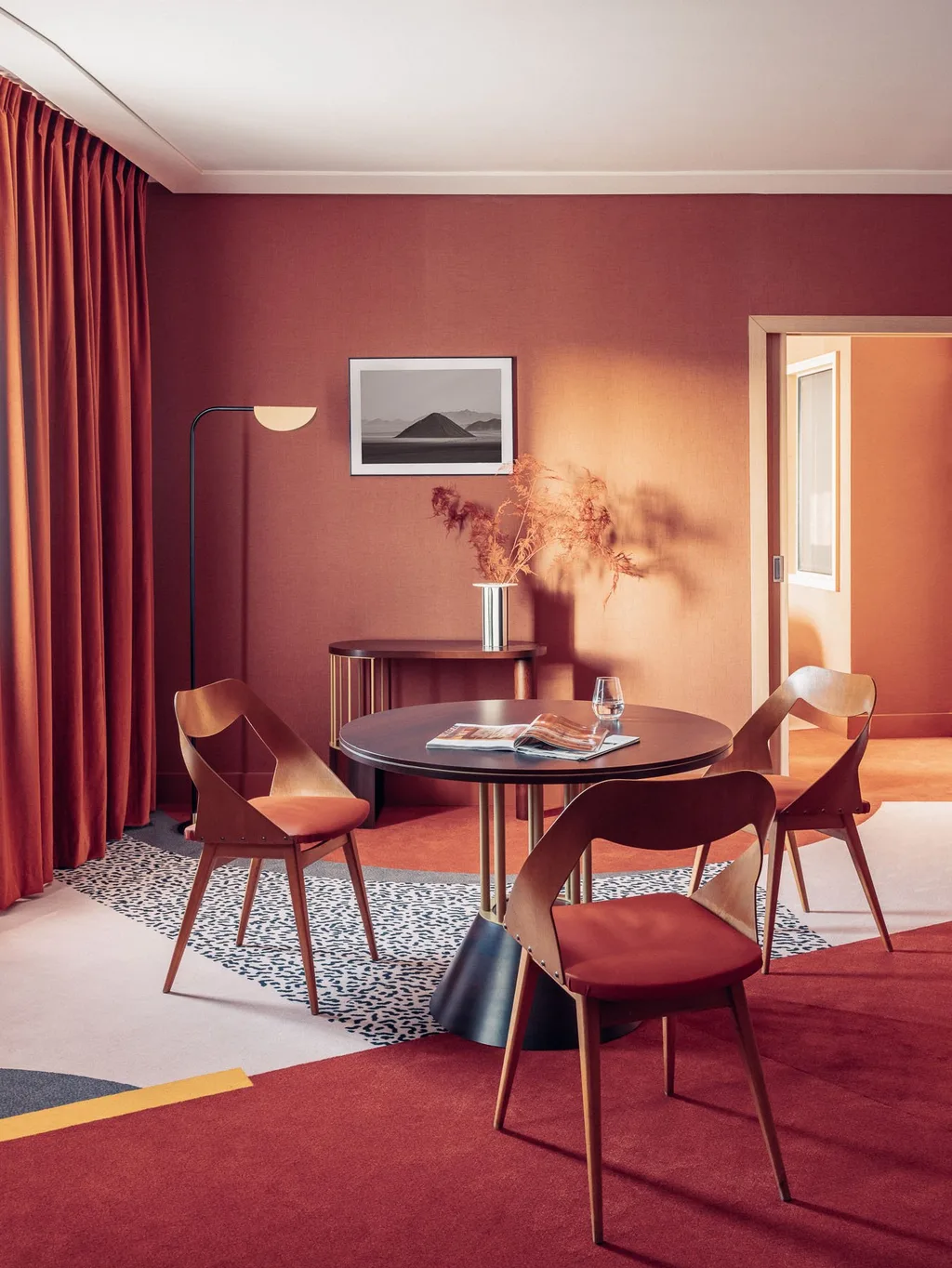 Lounge corner with round table, floor lamp and framed landscape photo, Nest MGallery Hotel, Paris