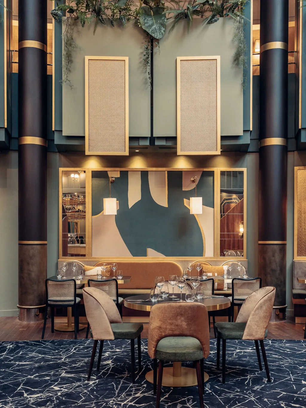 Green dining lounge with cane panels, hanging plants and marble floor, Nest MGallery Hotel, Paris