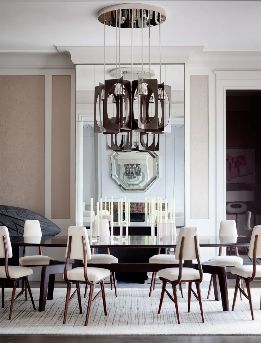 Dining room with pale chairs, tall candles and a sculptural chandelier, Jean Louis Deniot, Paris
