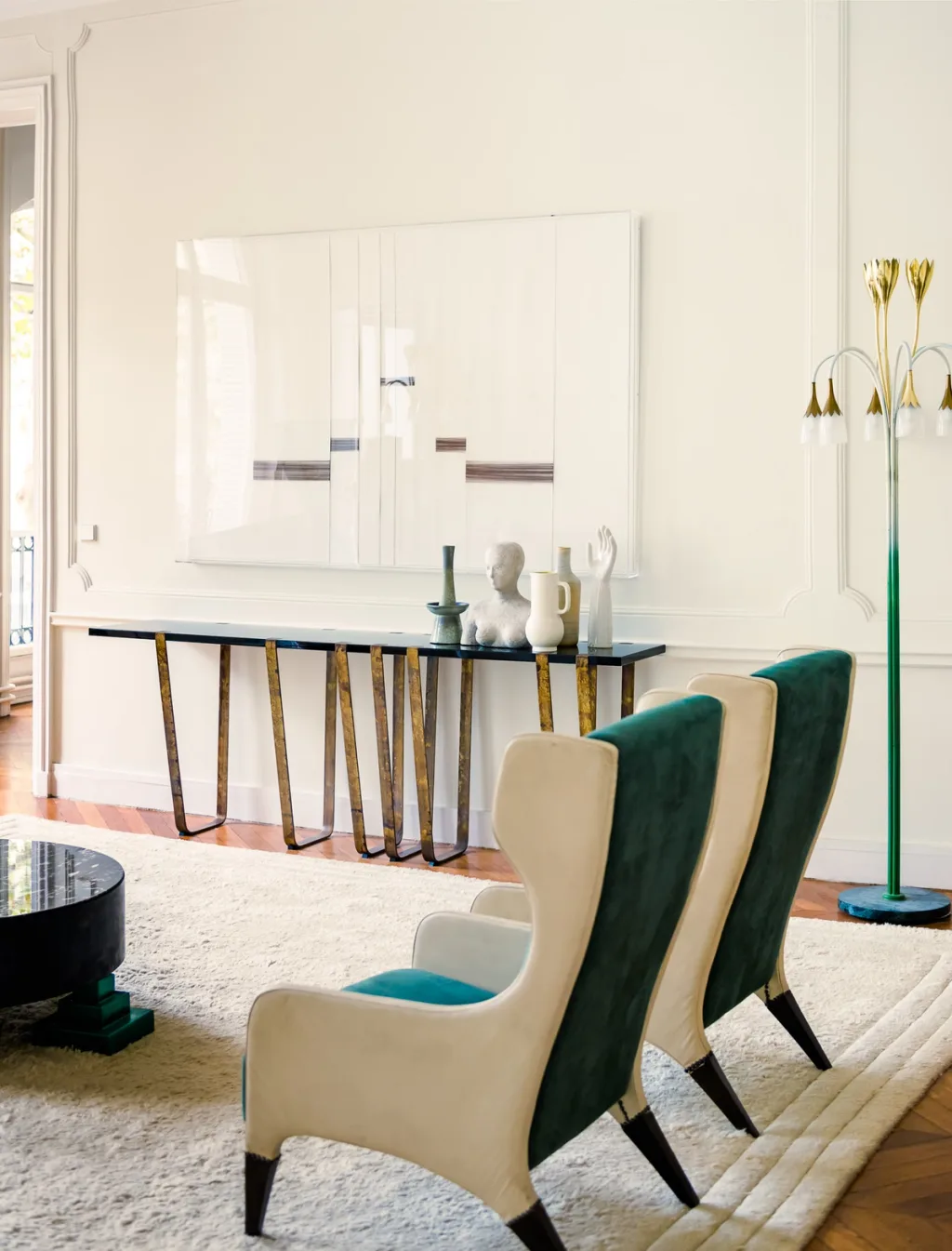 Green-and-cream wingback chairs facing a long slender console, Dimore Studio, Paris