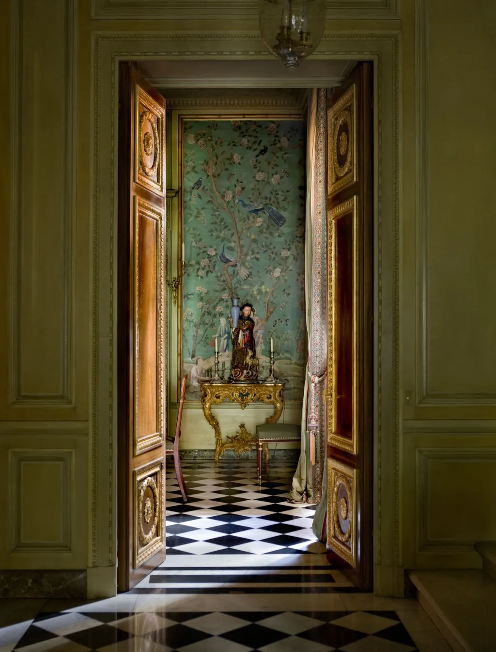 Gilded open doors revealing a painted green room and chequered floor, Pierre Bergé, Paris