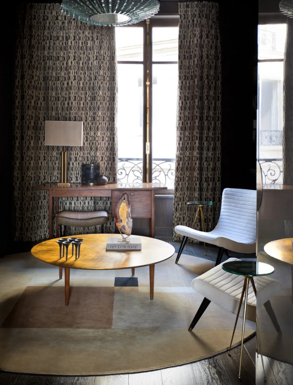Sitting area with a round golden table and patterned curtains, Jean Louis Deniot, Paris